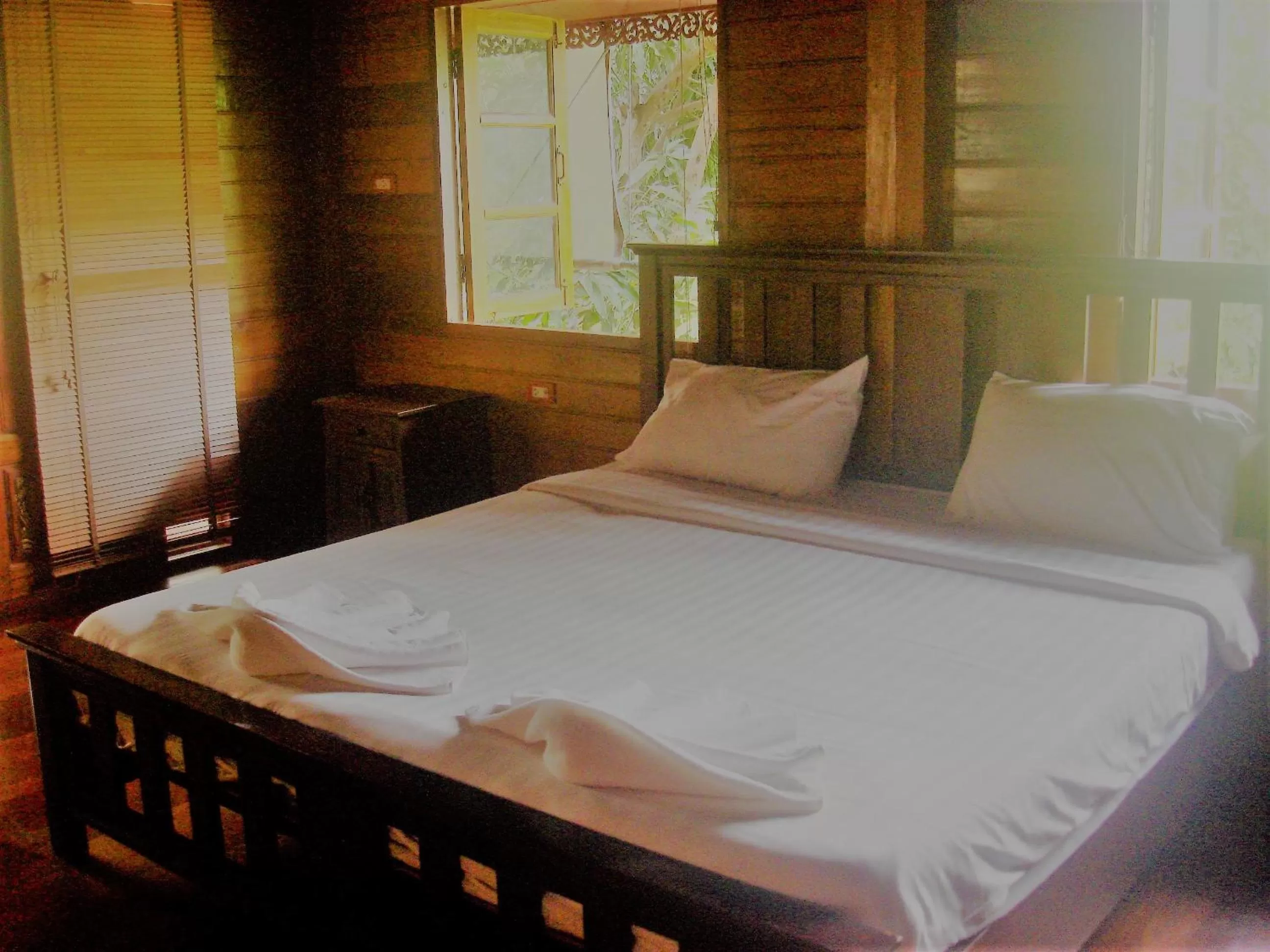 Bed in Cozy Garden Resort