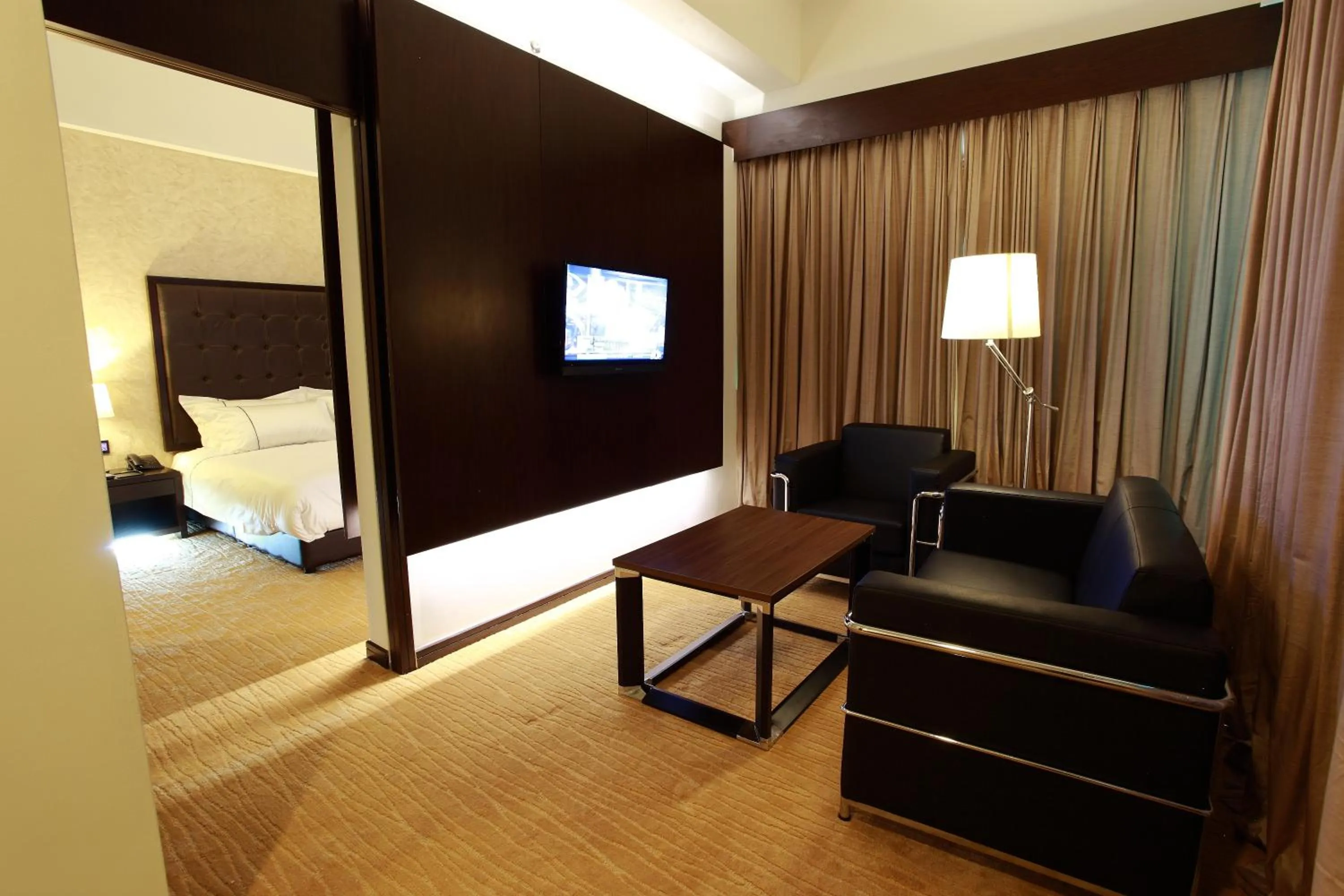 Living room, Bed in Symphony Suites Hotel