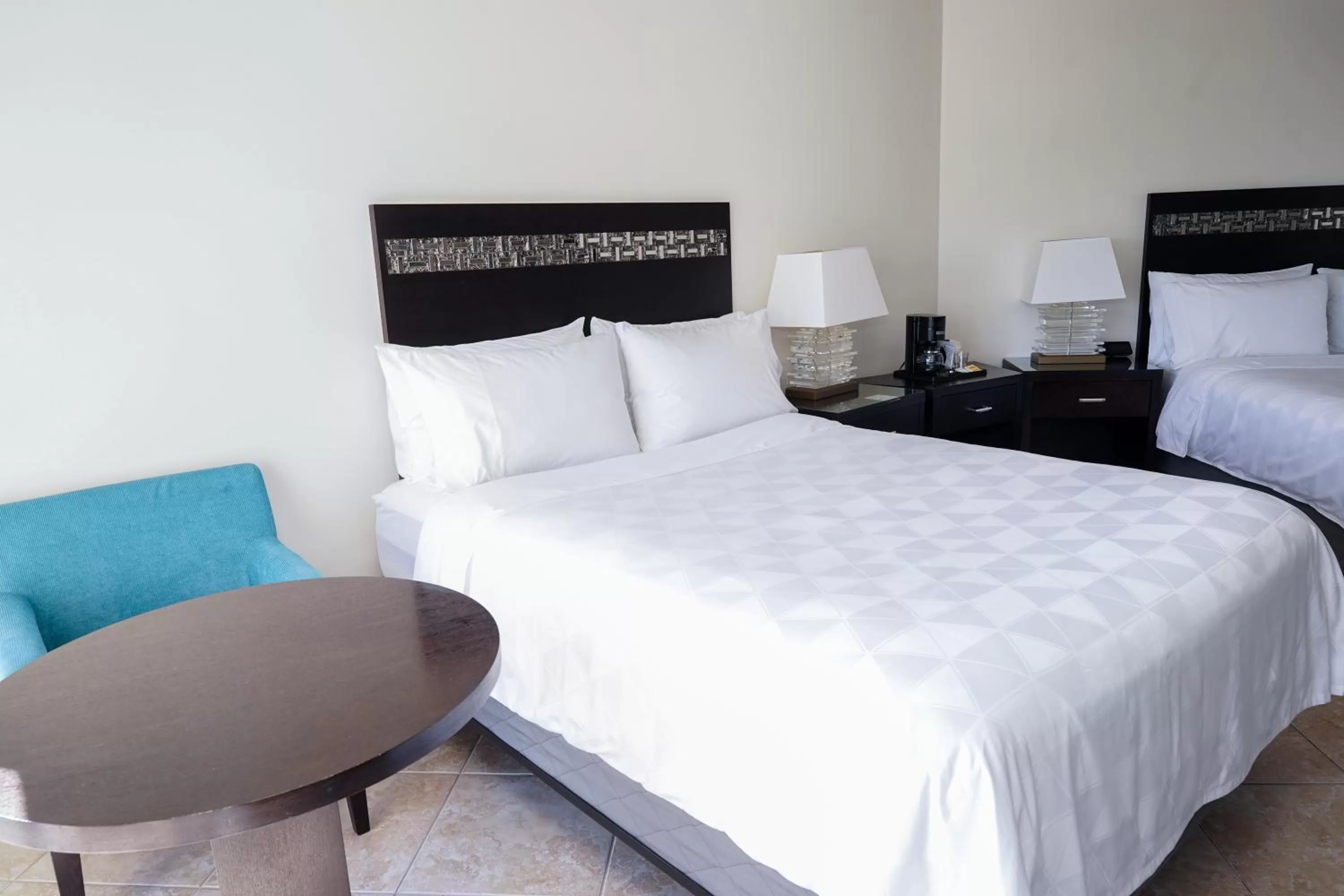 Seating area, Bed in Holiday Inn Resort Grand Cayman by IHG