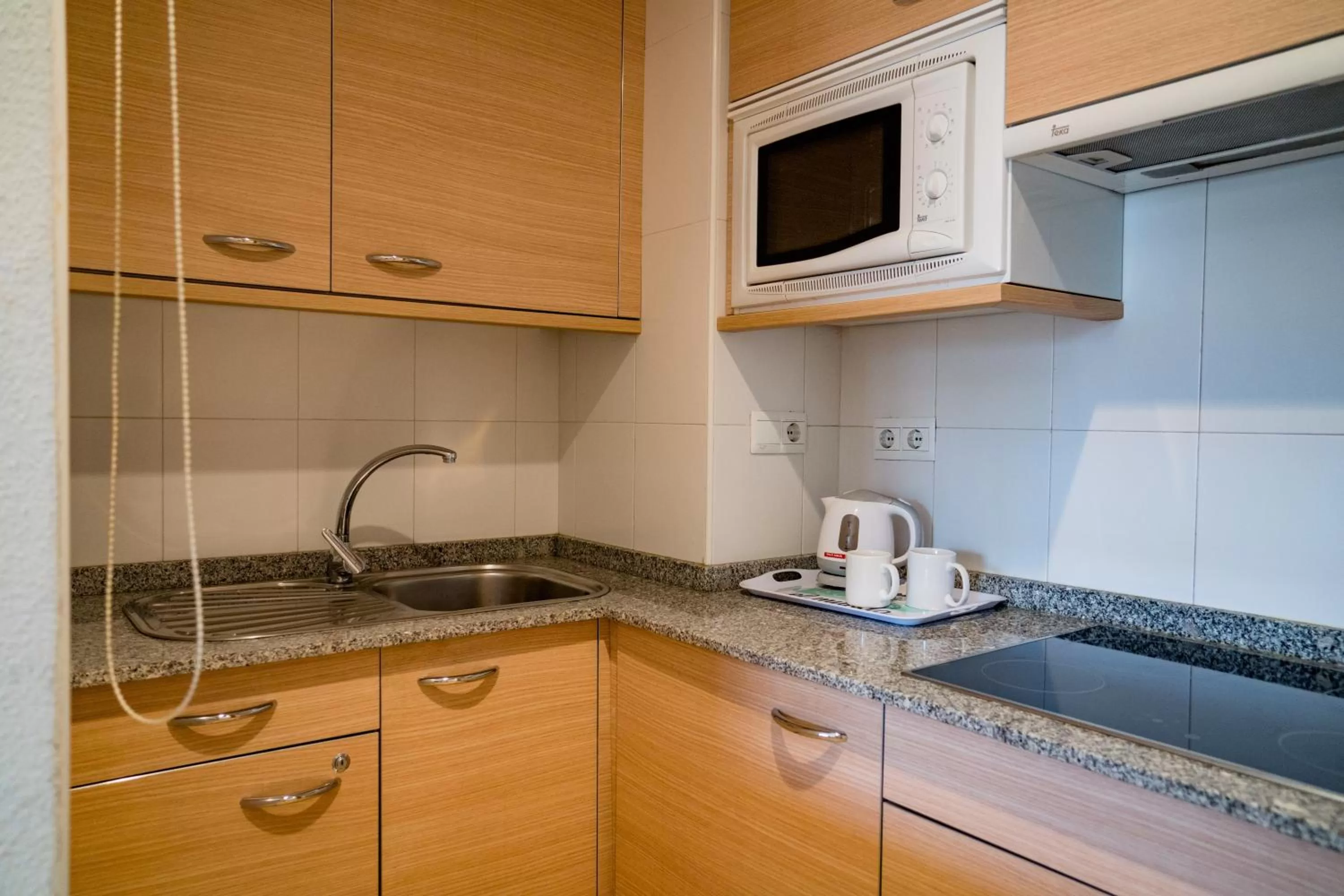 Kitchen or kitchenette in Compostela Suites