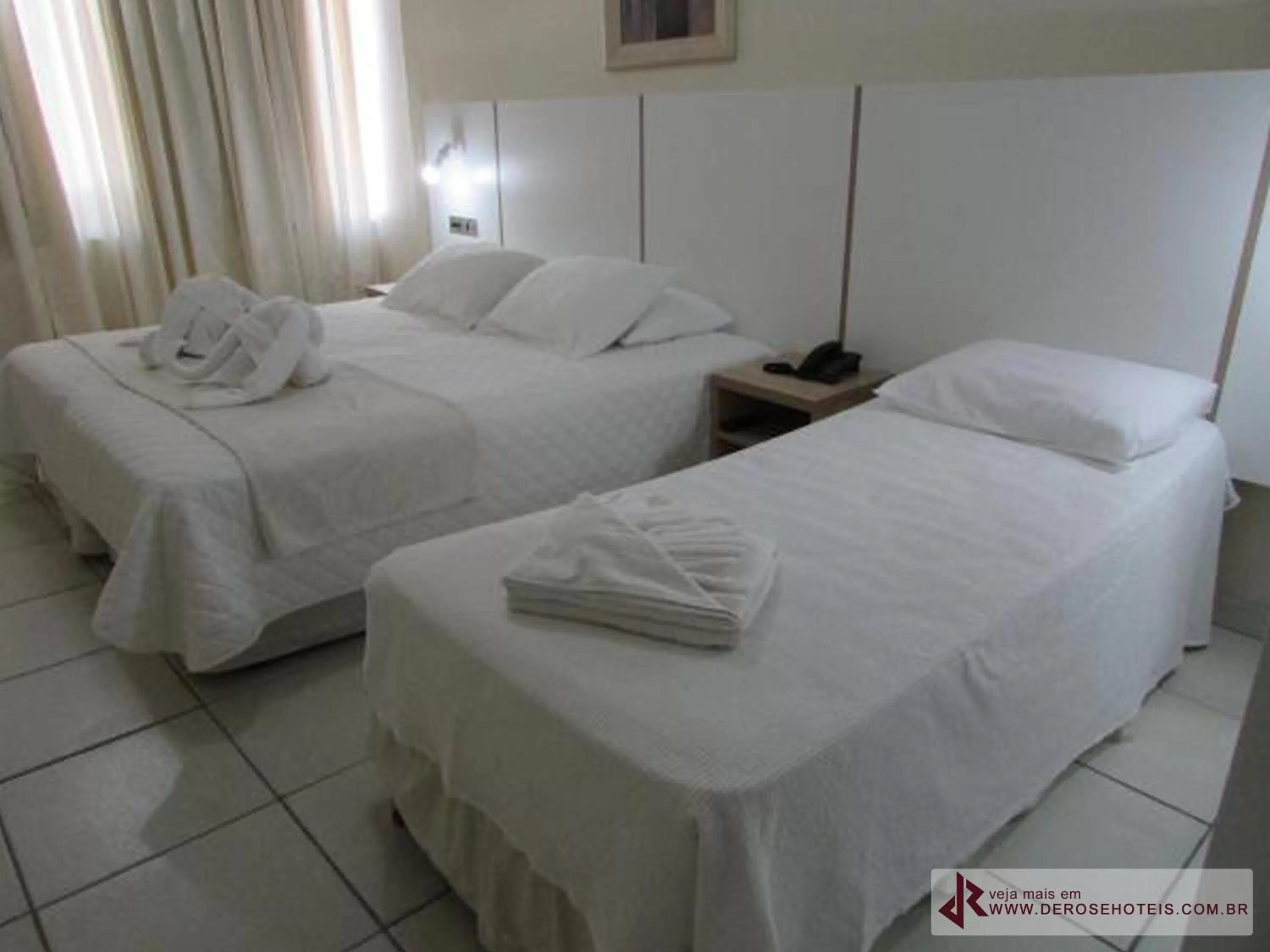 Bed in De Rose Palace Hotel