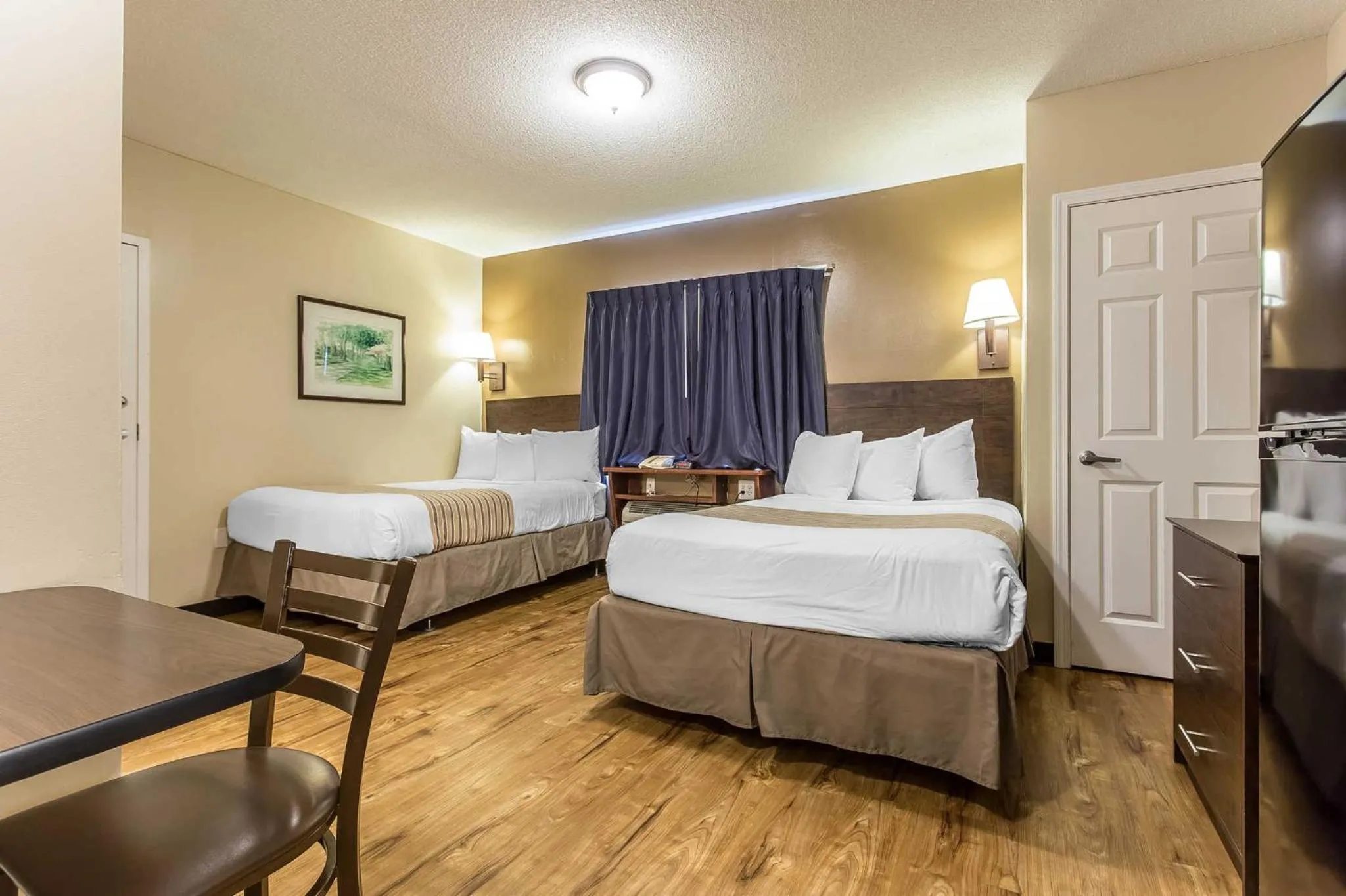 Photo of the whole room, Bed in Suburban Studios near University of North Carolina-Charlotte