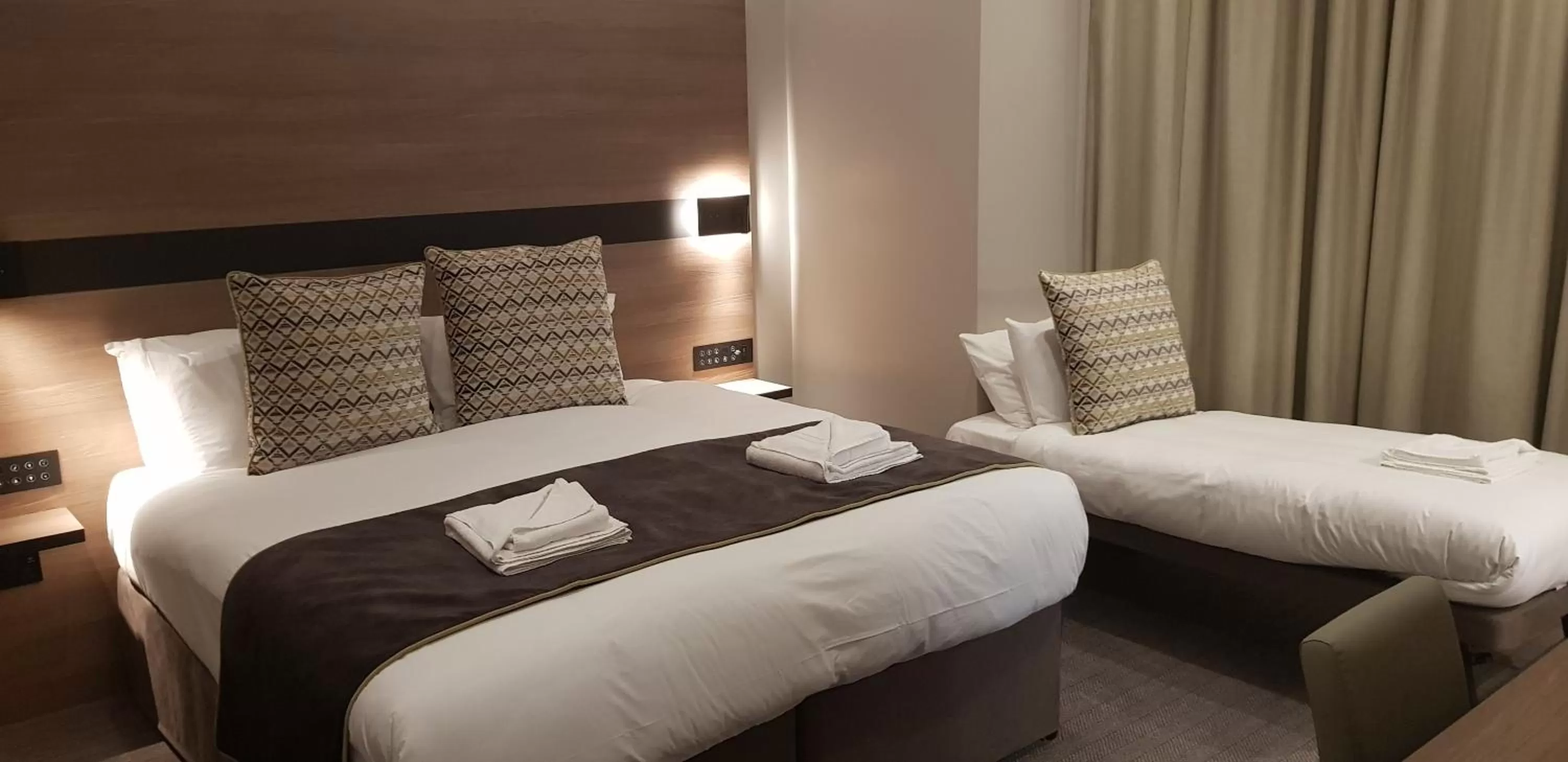 Bed in Merit Kensington Hotel