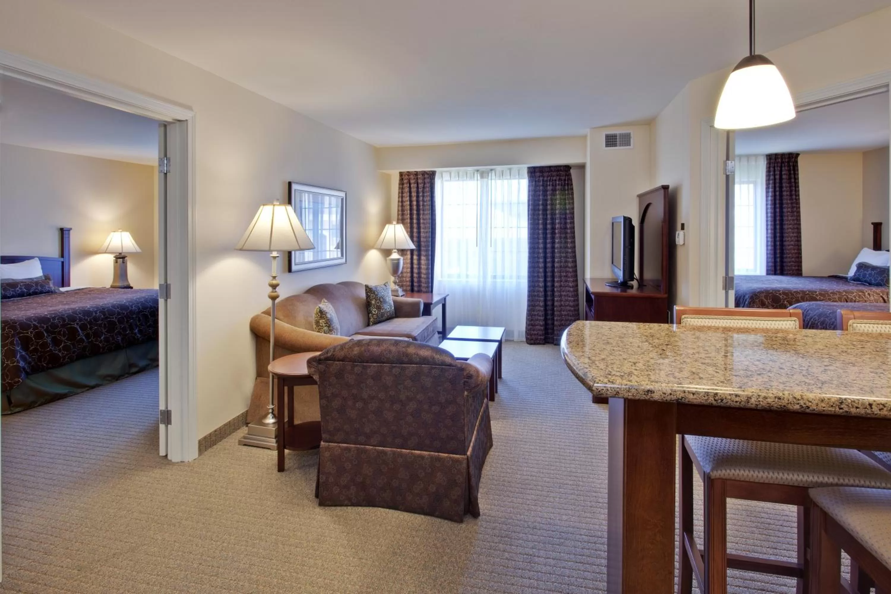 Living room, Bed in Staybridge Suites Indianapolis-Carmel by IHG