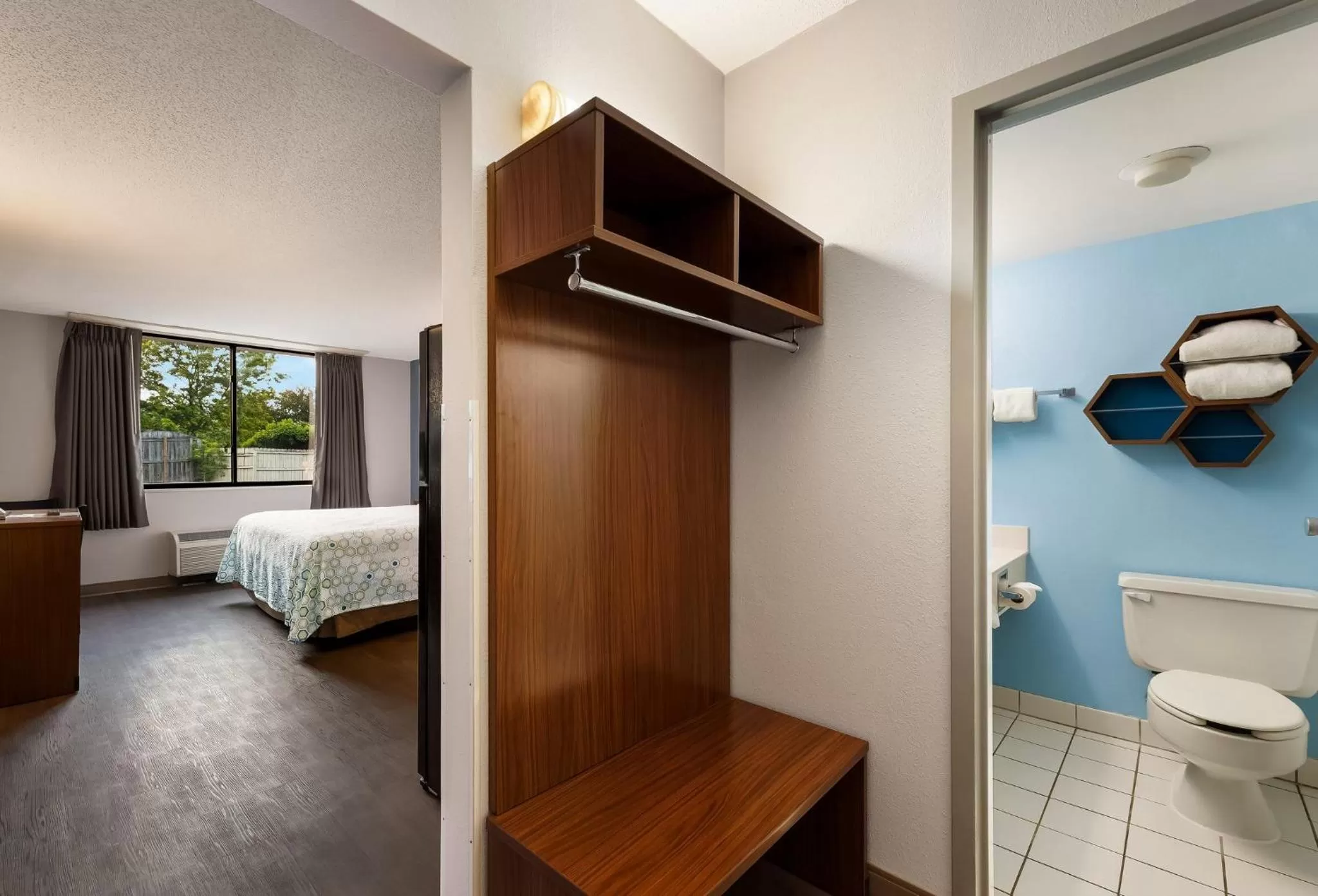 Photo of the whole room, Bed in HomeTowne Studios by Red Roof Painted Post