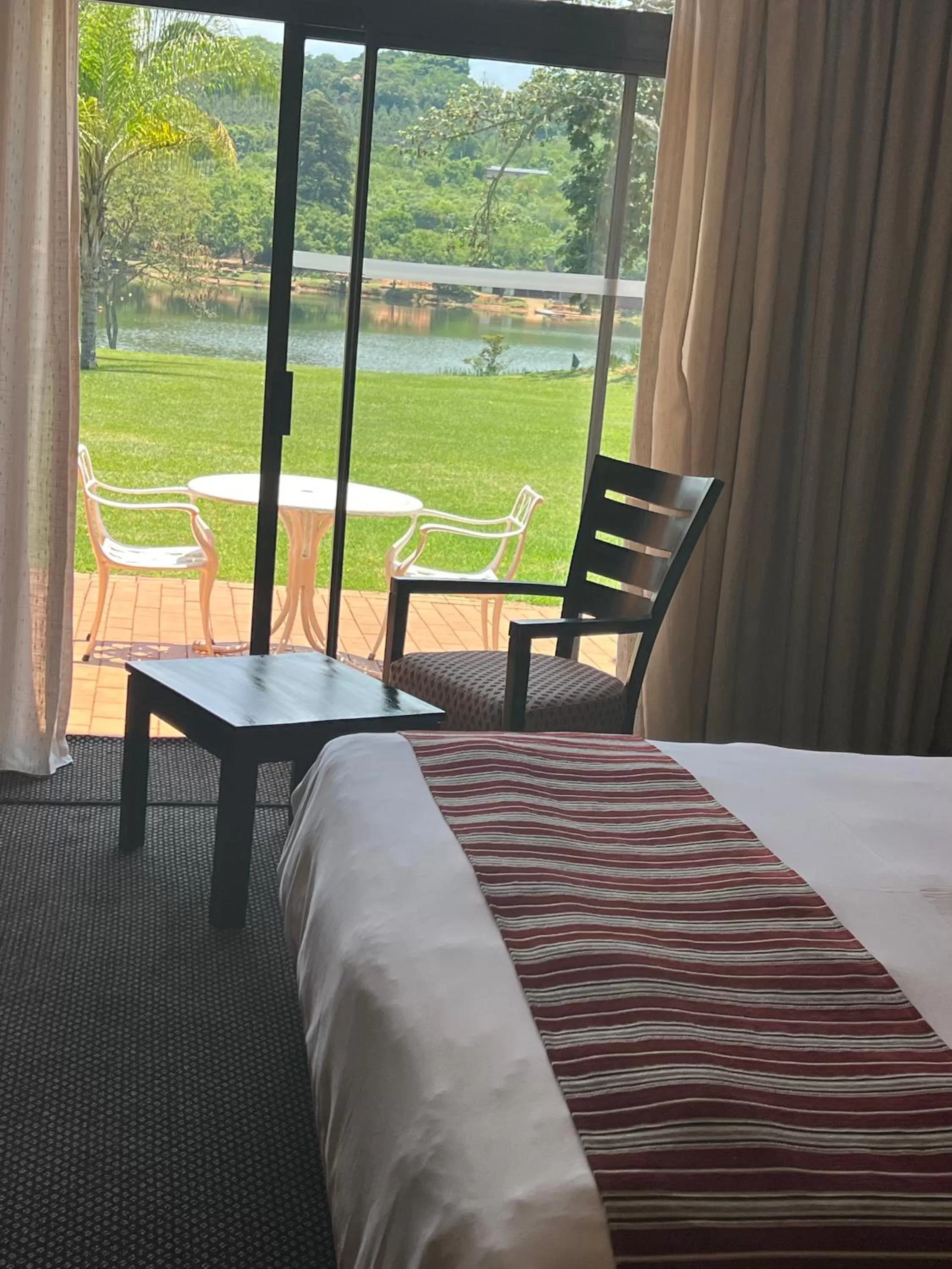 View (from property/room), Bed in African Sky Hotels - Pine Lake Inn