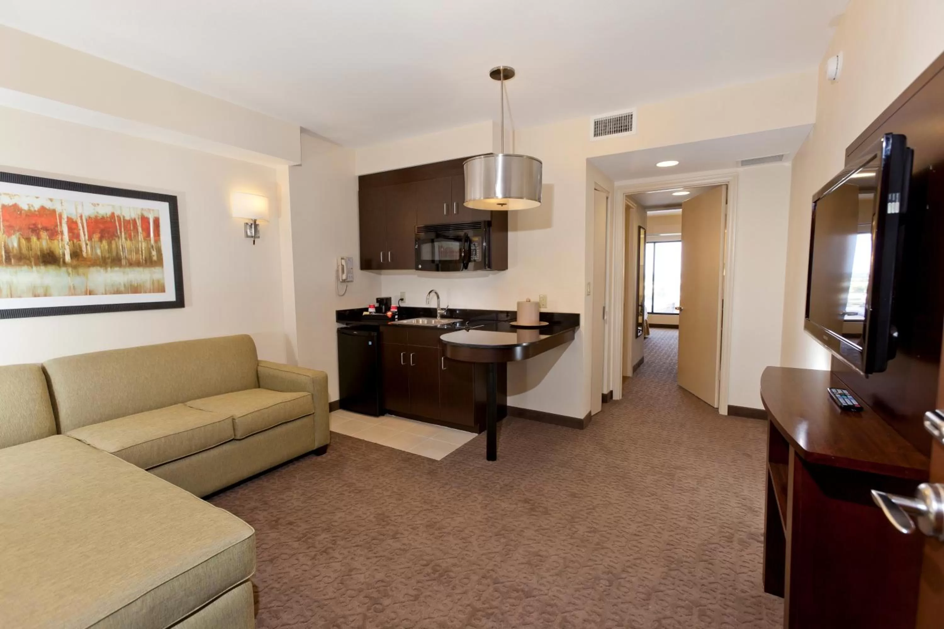 Living room in Ramada Plaza by Wyndham Orlando Resort & Suites Intl Drive - Newly Renovated!