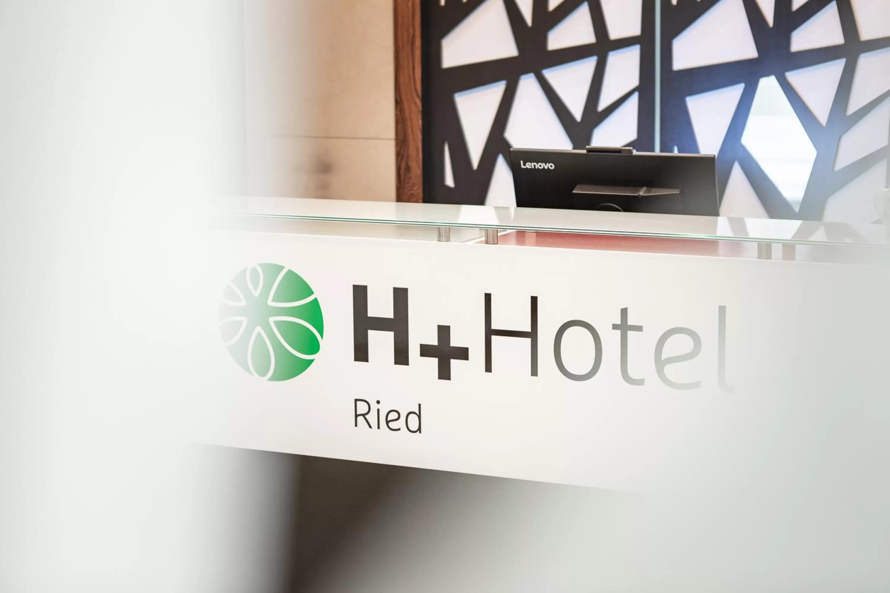 Property logo or sign in H+ Hotel Ried