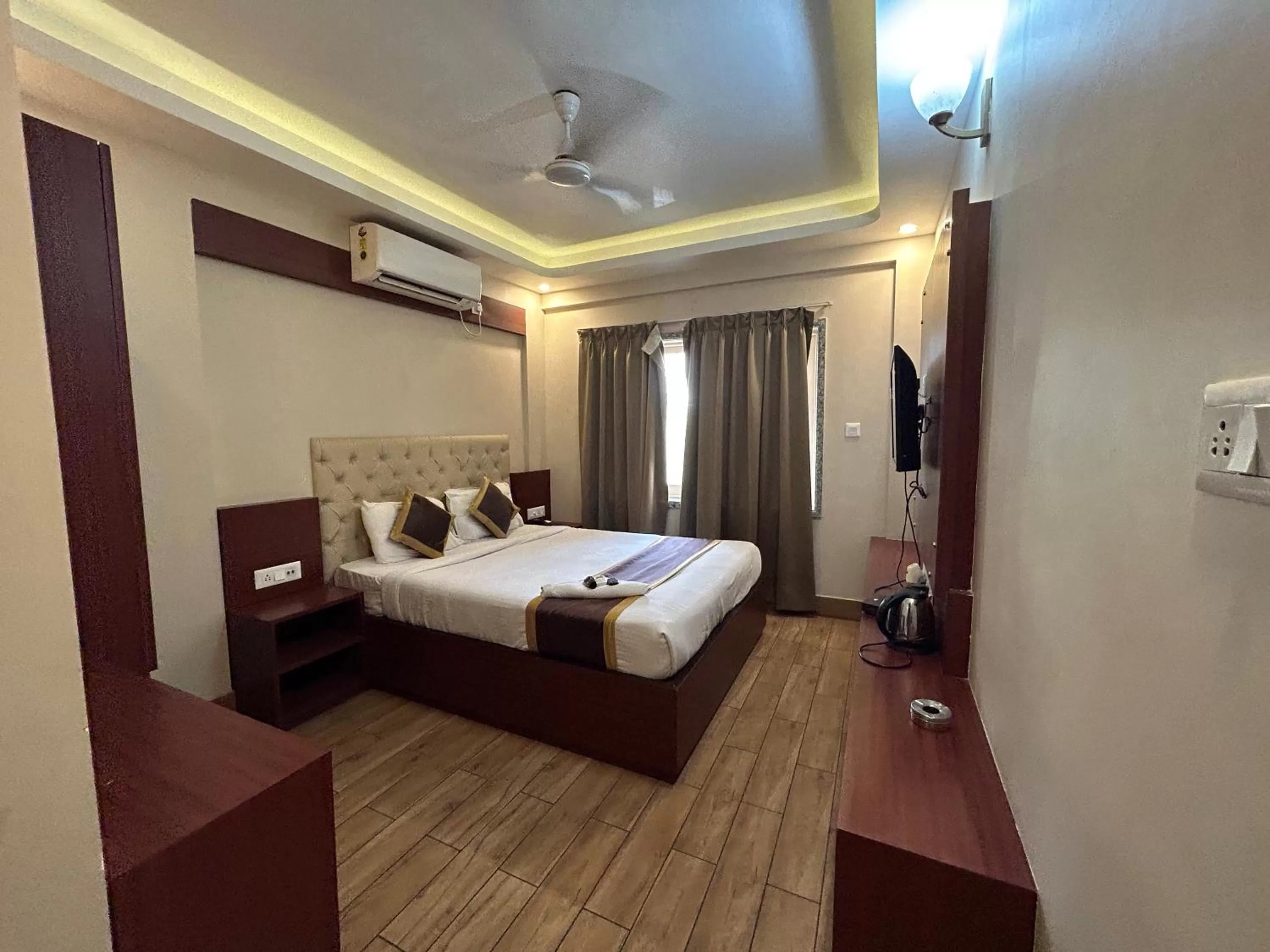 Bed in The Aster Enclave Hotel