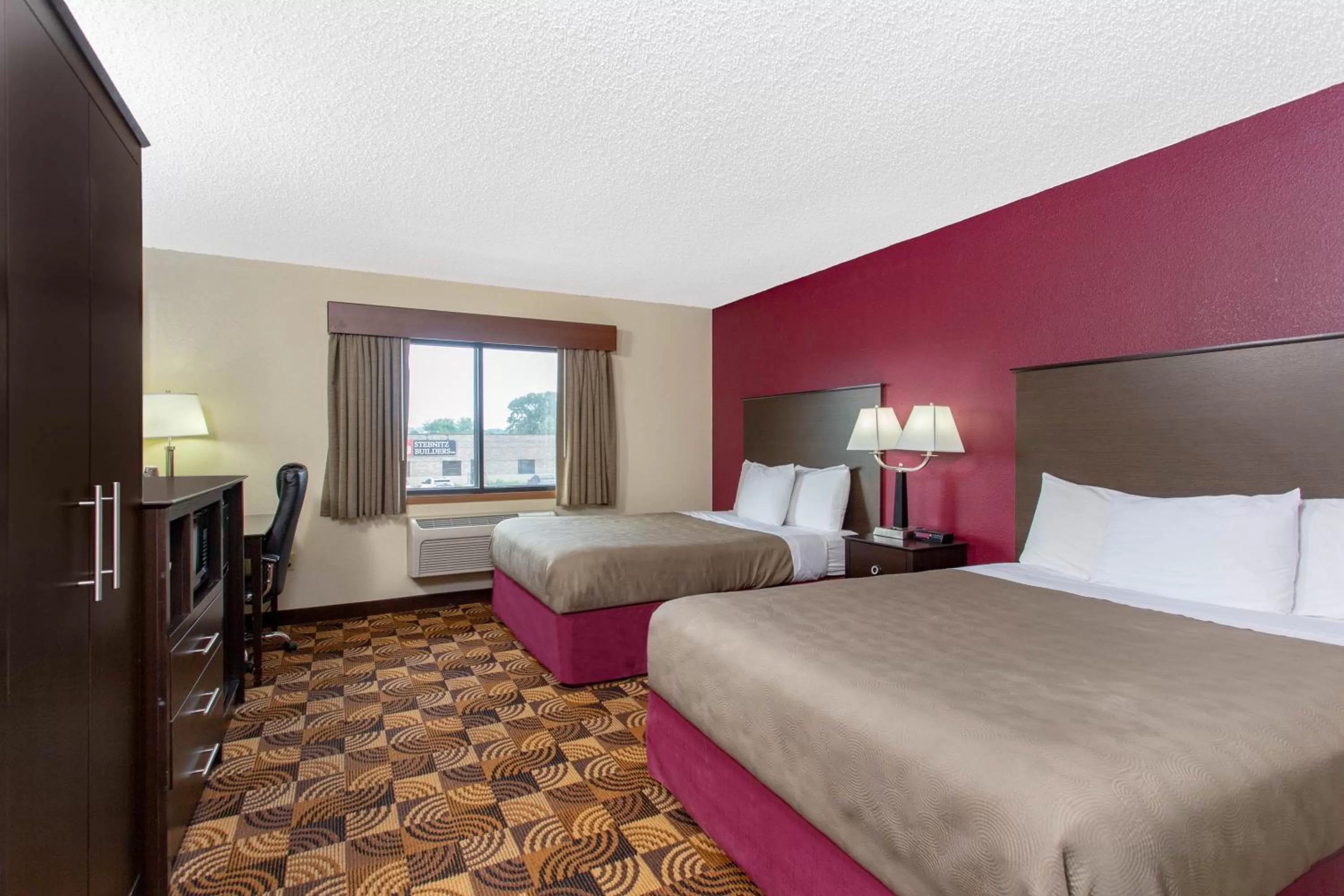Bed in AmericInn by Wyndham Elkhorn Near Lake Geneva