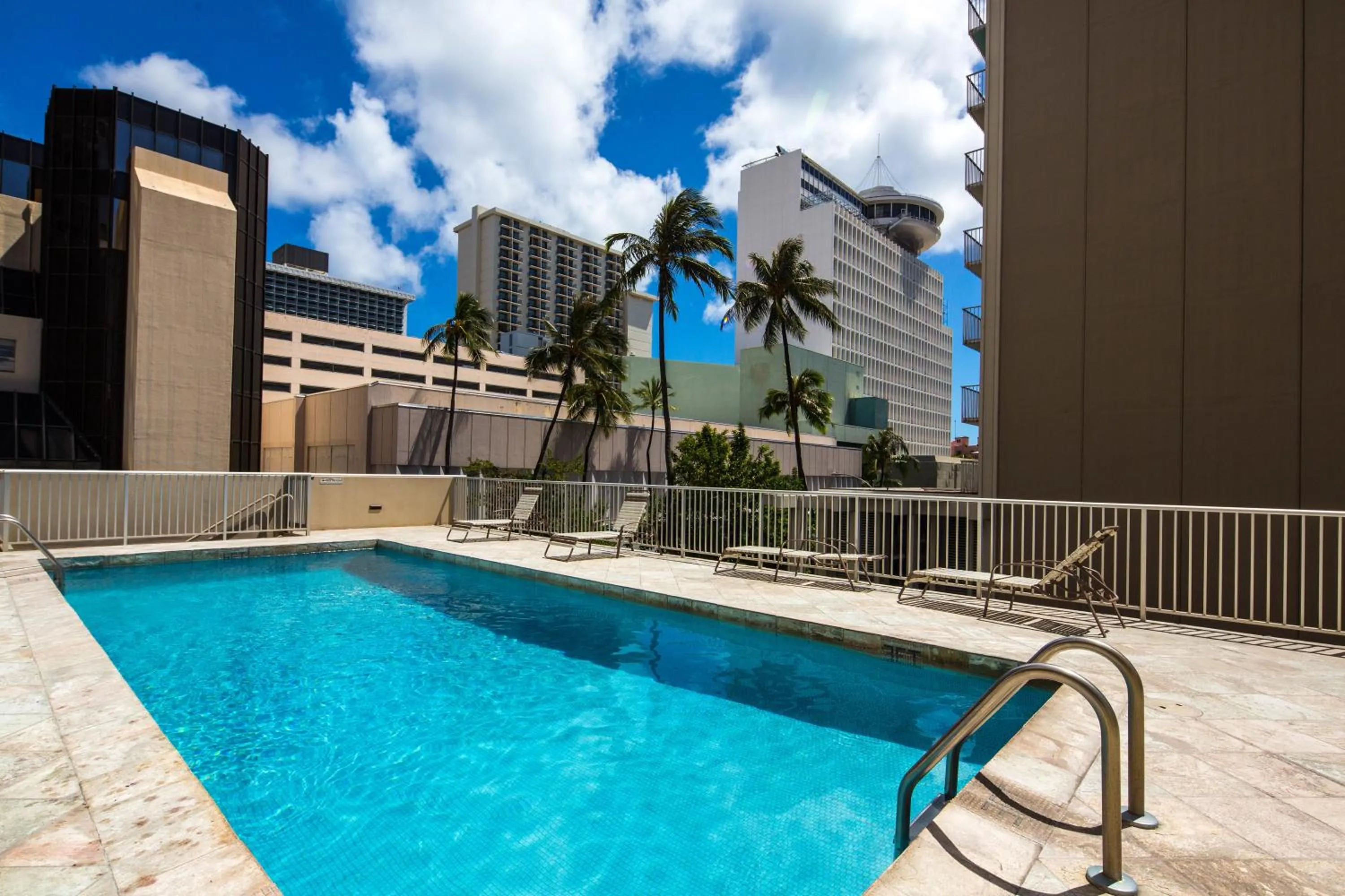 Swimming pool in Tropical Studios at Marine Surf Waikiki - FREE PARKING - BEST LOCATION - FULL KITCHEN - SWIMMING POOL