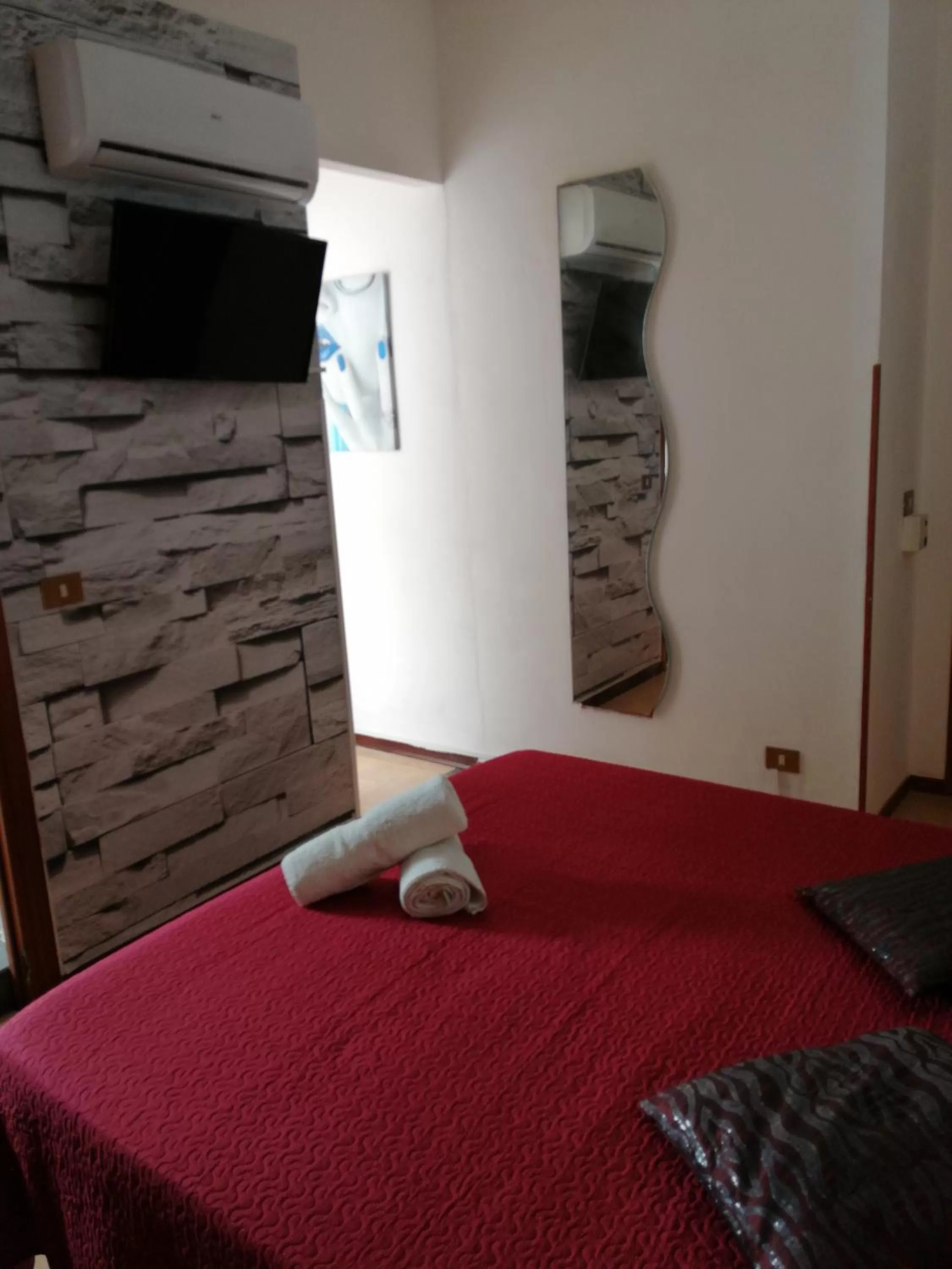 Bed in Le Rocce Holiday Rooms