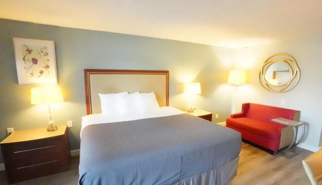 Bed in All Seasons Inn & Suites