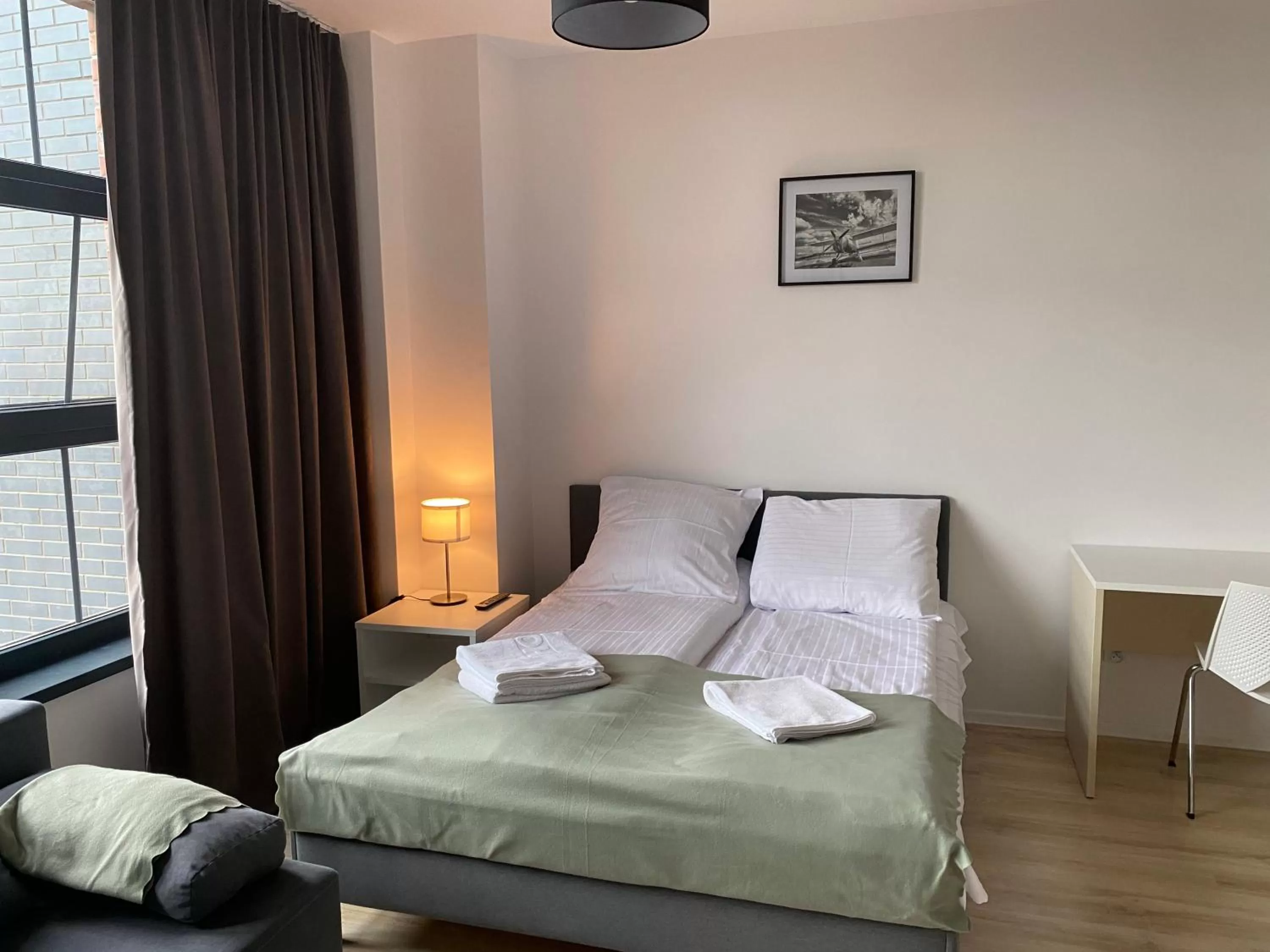 Bed in SleepWell Apartments