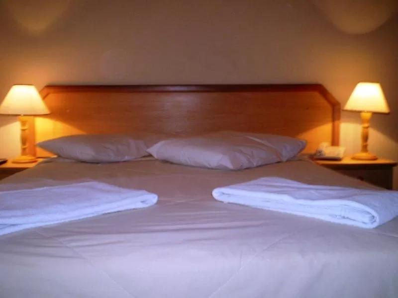 Bed in Hotel Gravataí Center