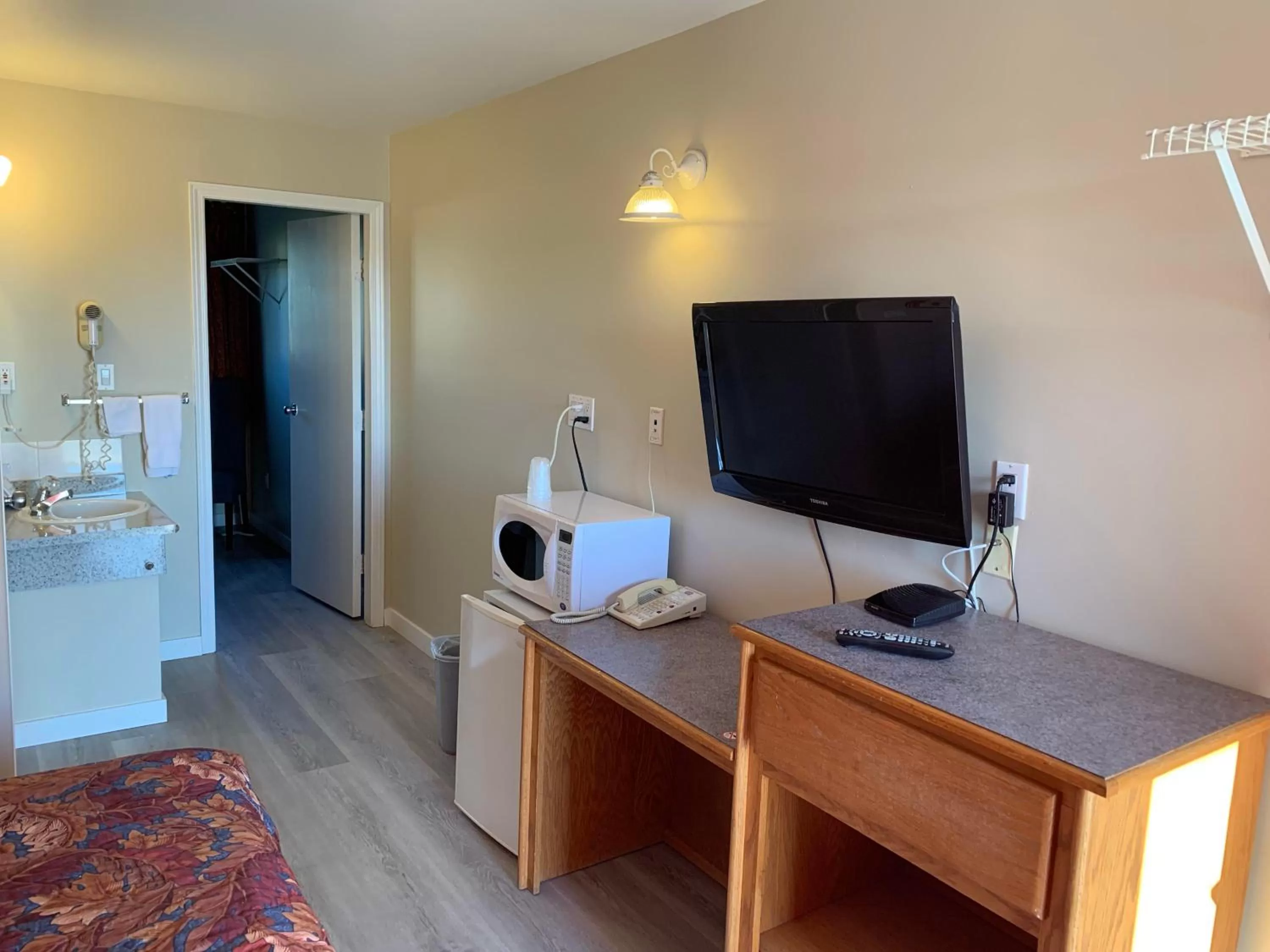 Bedroom, TV/Entertainment Center in Red Deer Inn & Suites