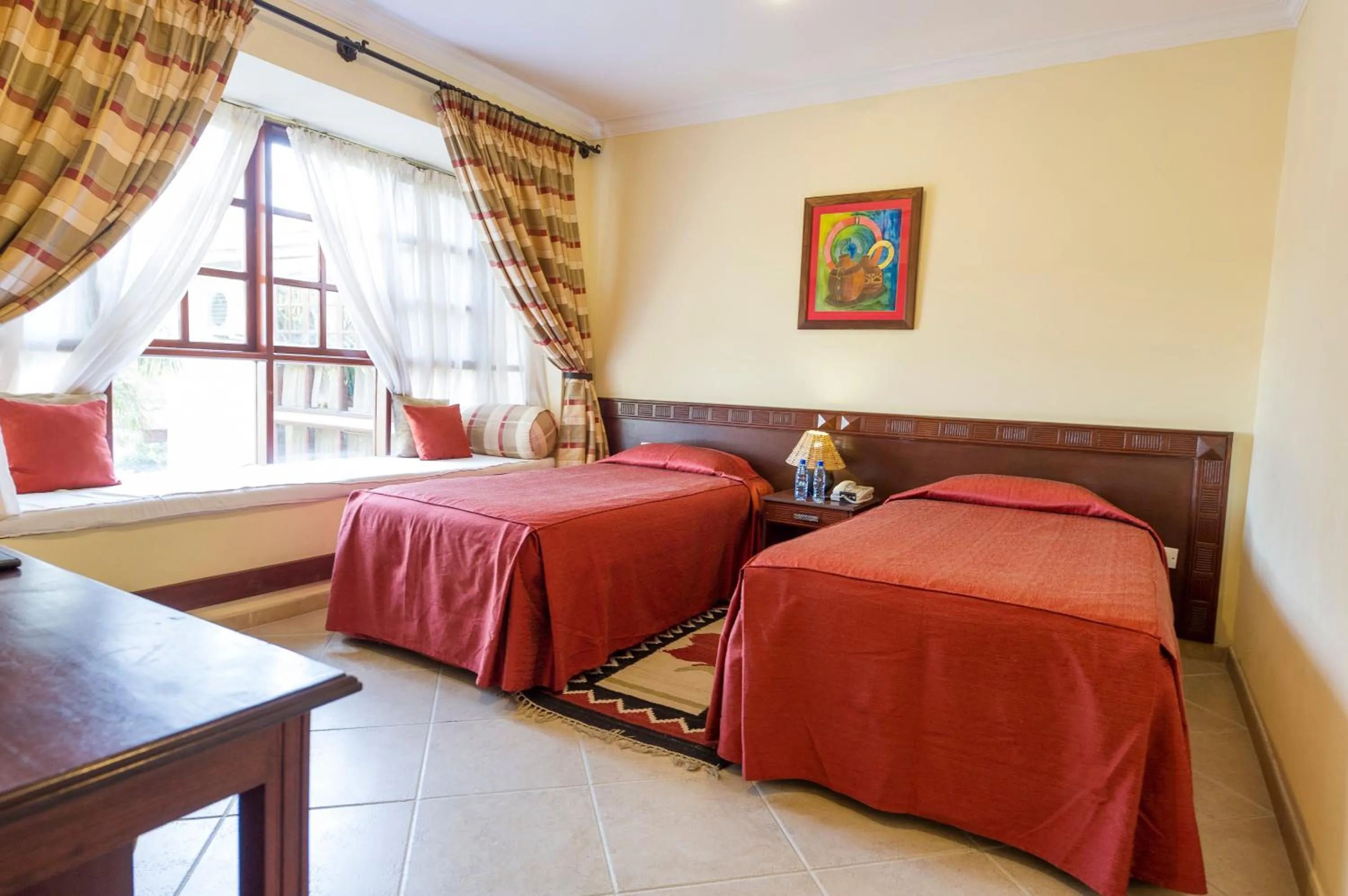 Bed in African Tulip Hotel