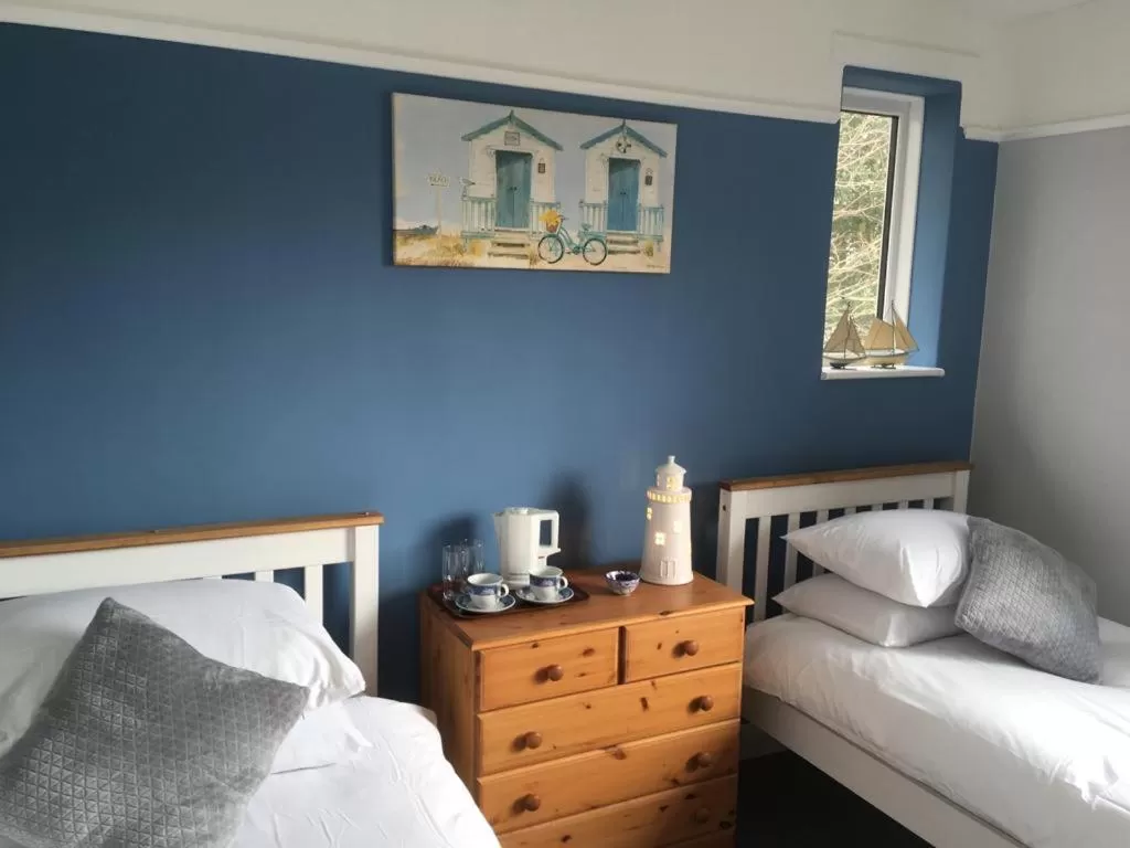 Bed in TRETHEWEY GUEST HOUSE