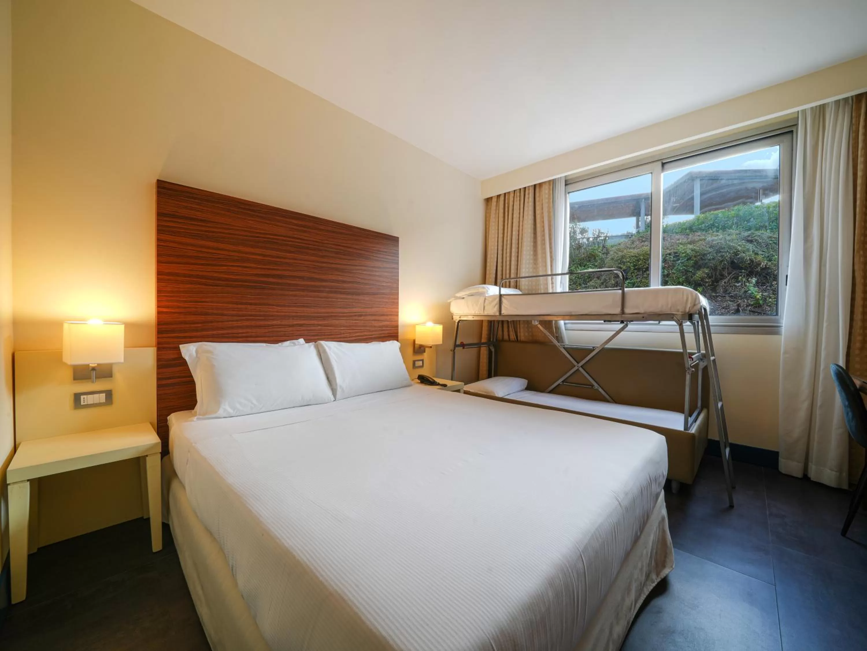 Bed in La Meridiana Bleisure Hotel