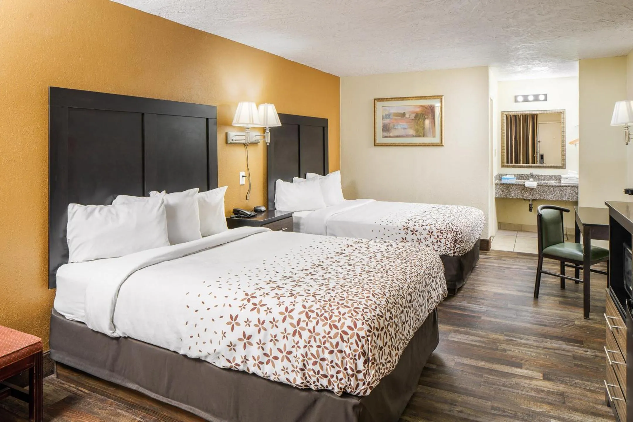 Bed in Americana Inn a Travelodge by Wyndham