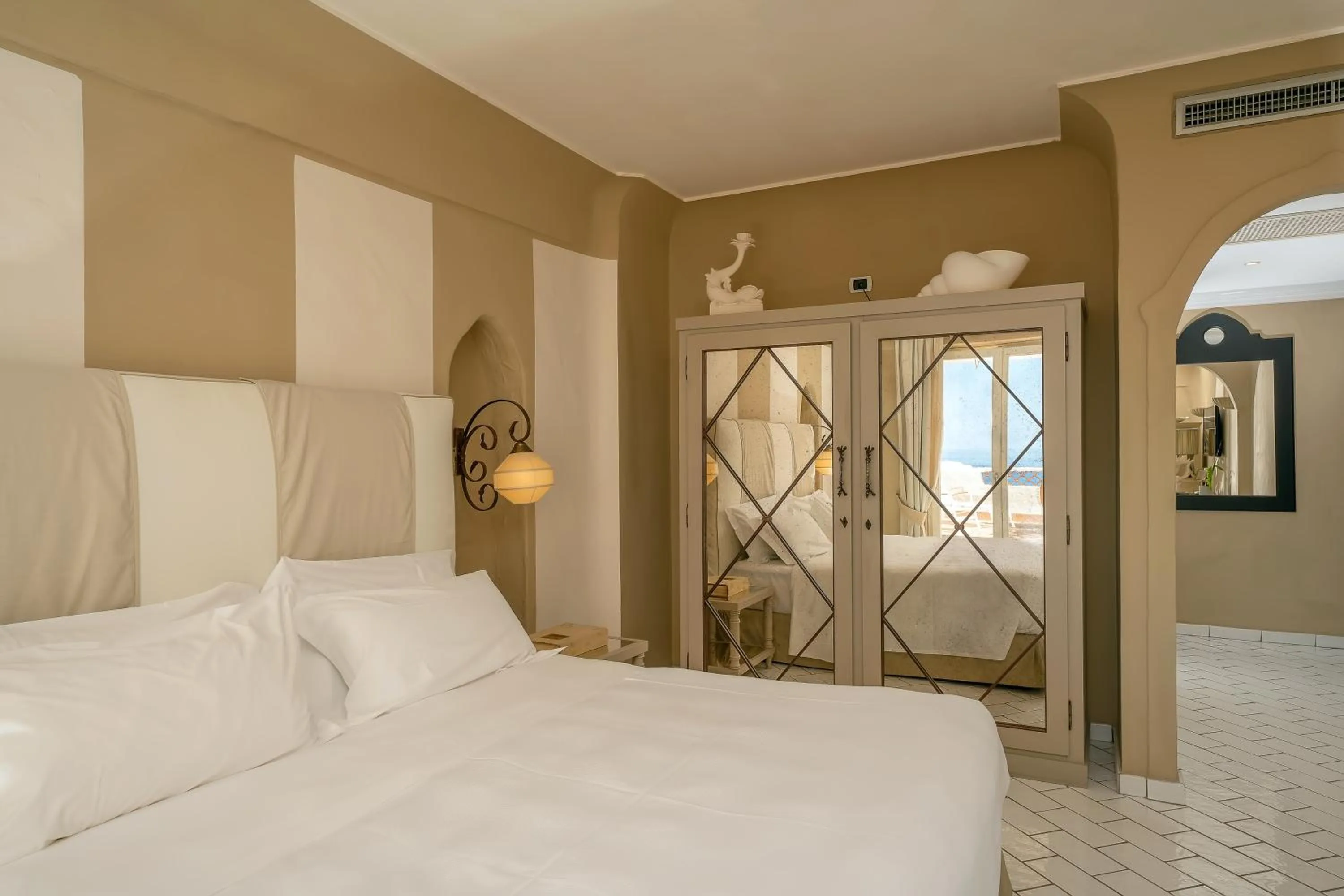 Bed in Therasia Resort Sea and SPA - The Leading Hotels of the World