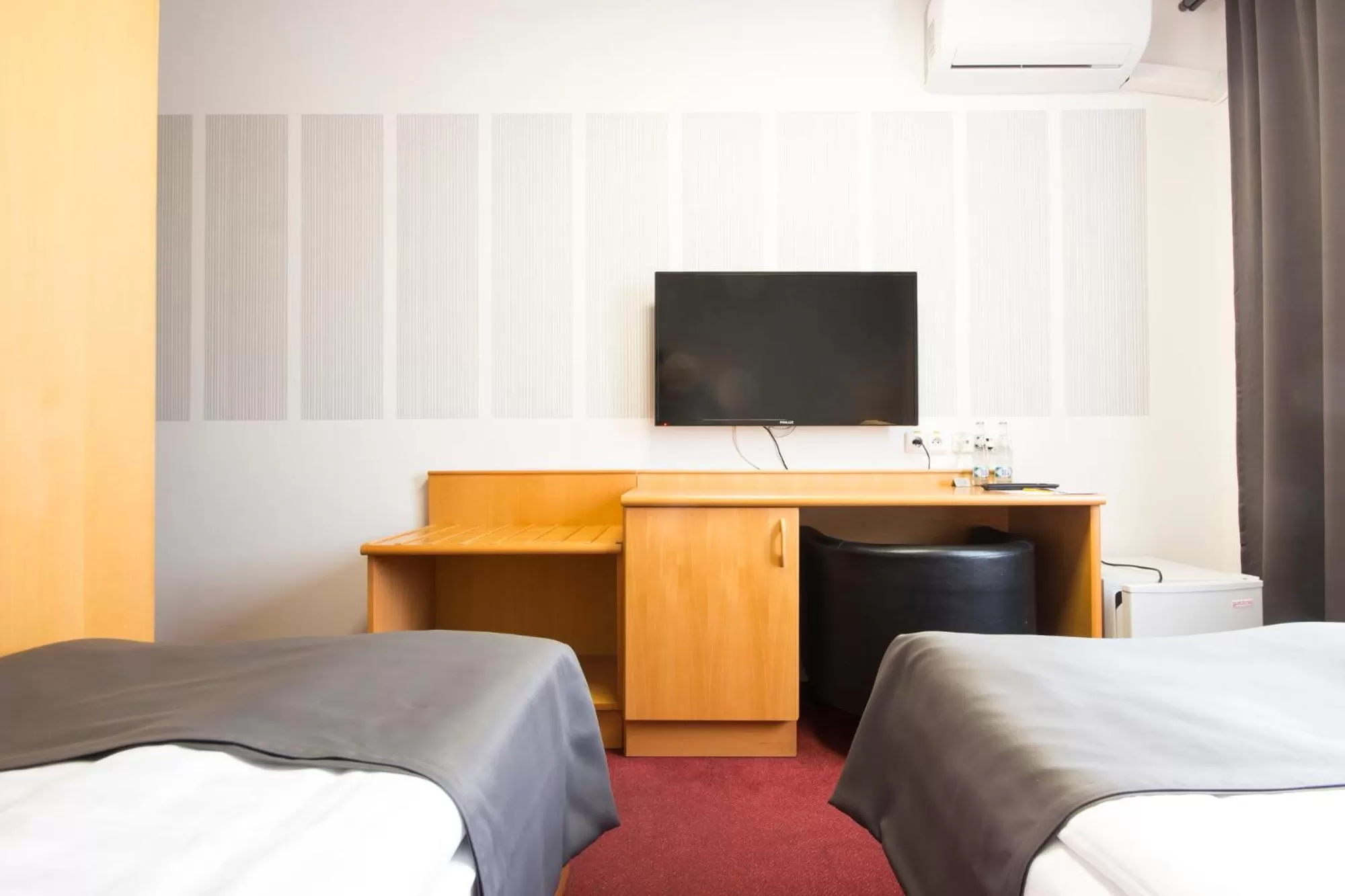 Bed, TV/Entertainment Center in Hotel Maroli Mikulov