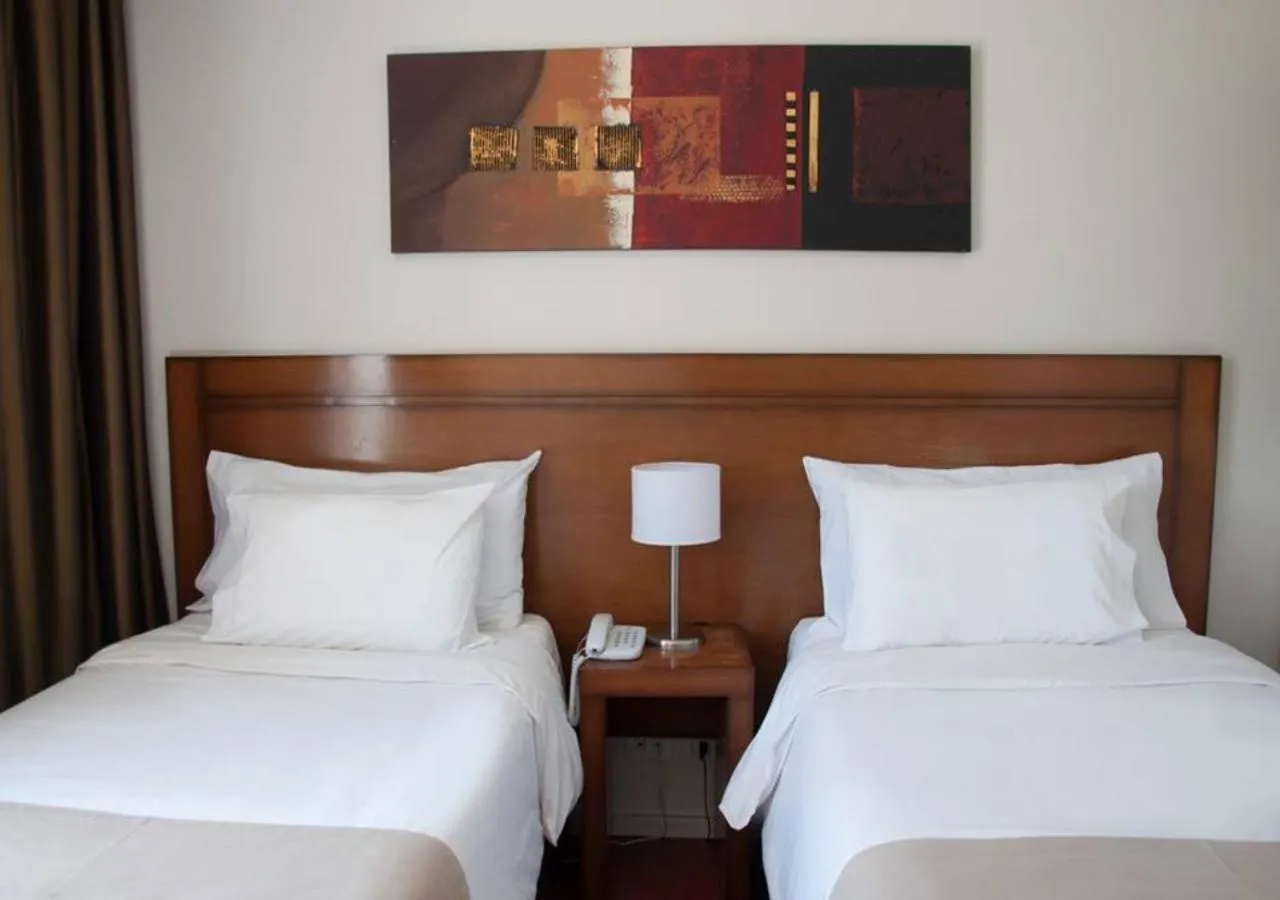 Bed in Herradura Hotel Suites