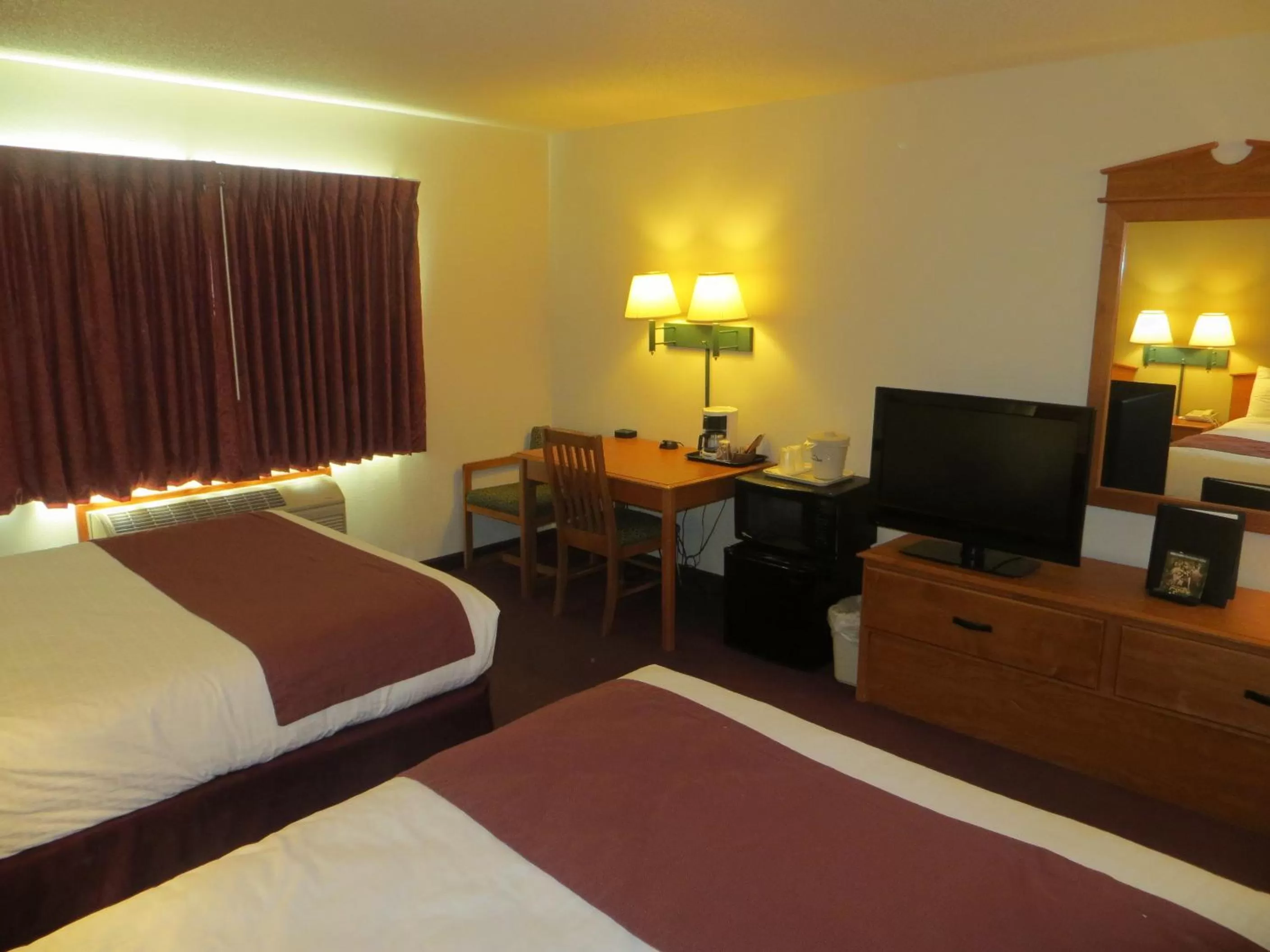 Bed in AmericInn by Wyndham Manitowoc