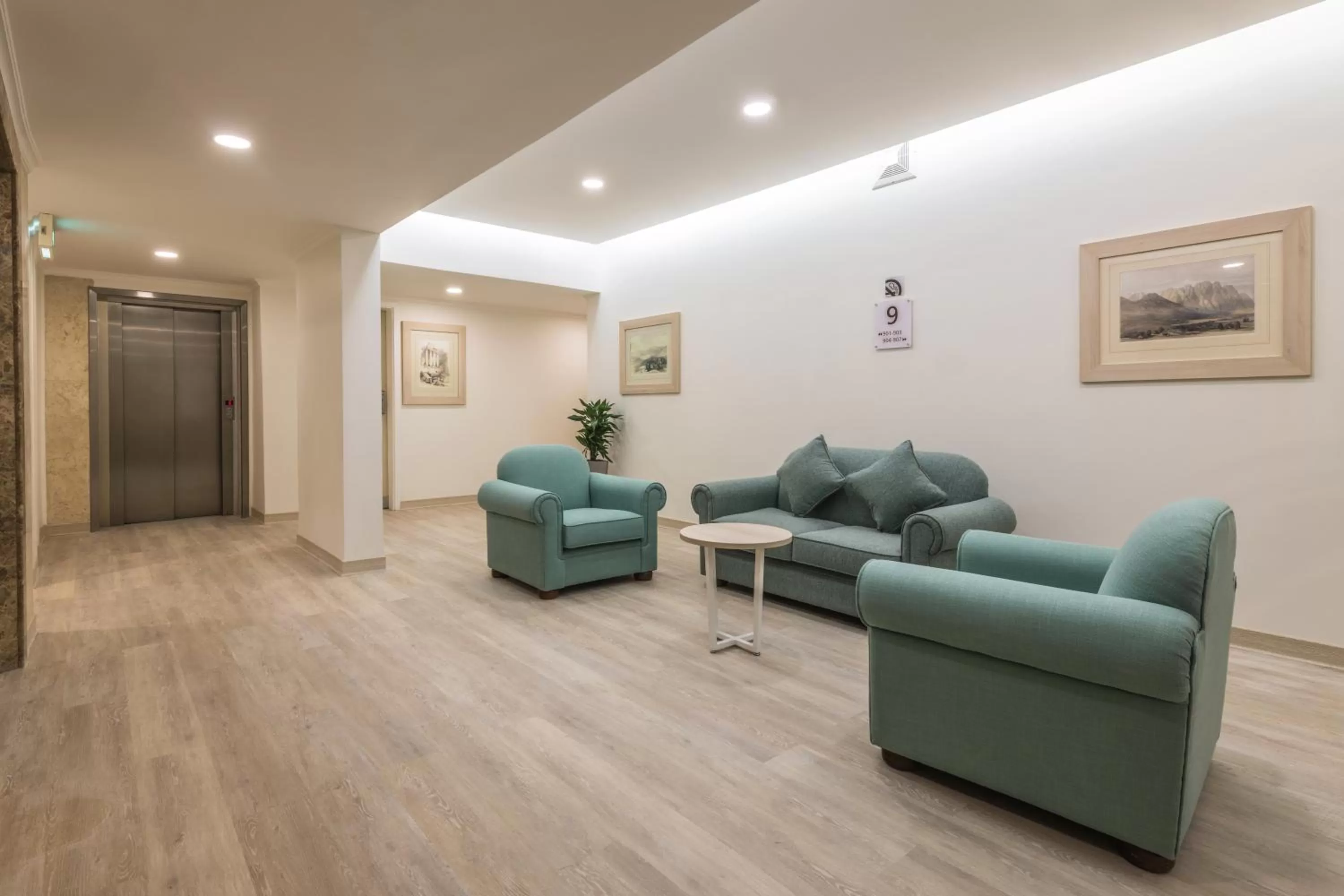 Communal lounge/ TV room in Oasis Hotel