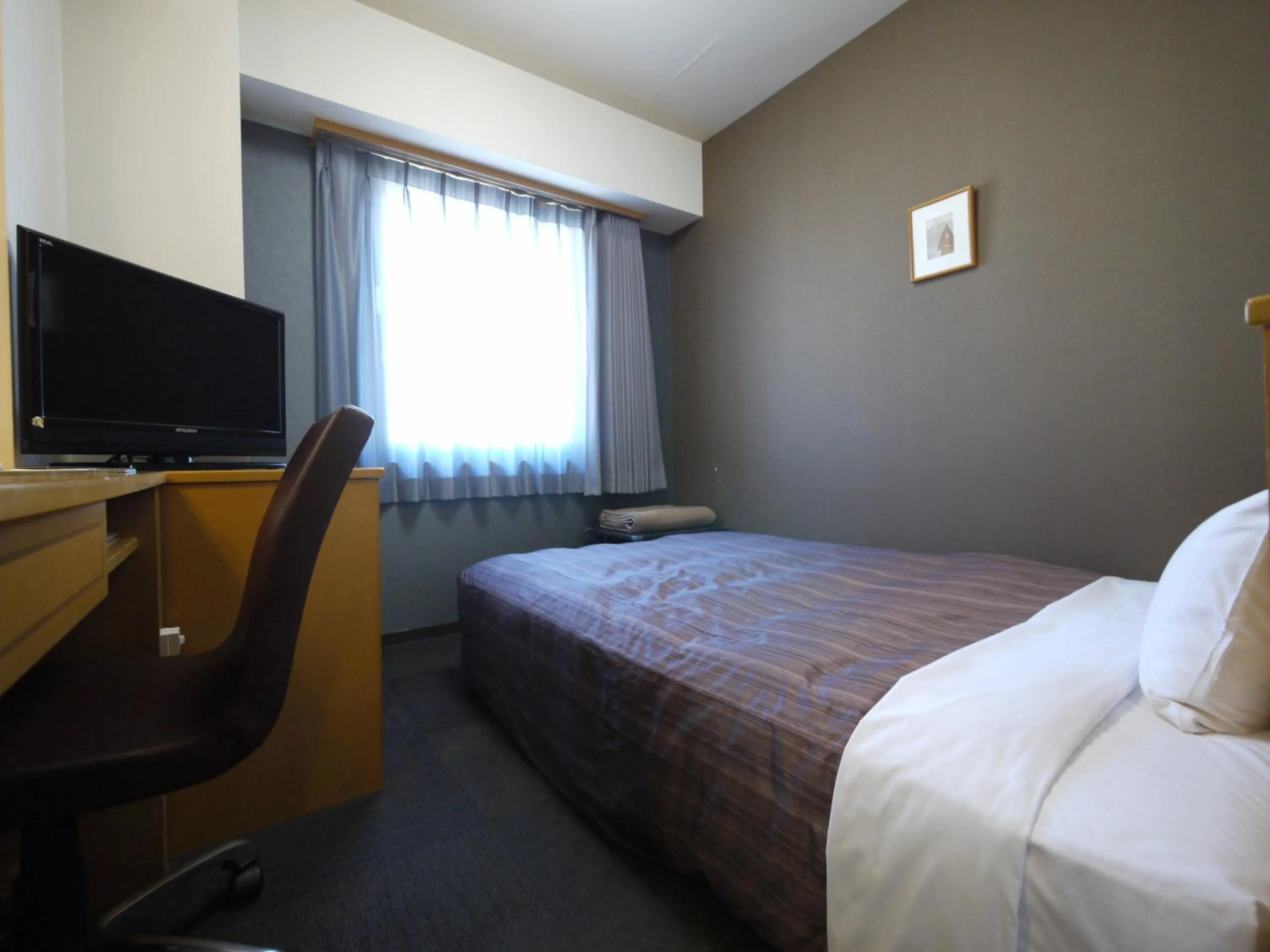 Photo of the whole room, Bed in Hotel Route-Inn Obihiro Ekimae