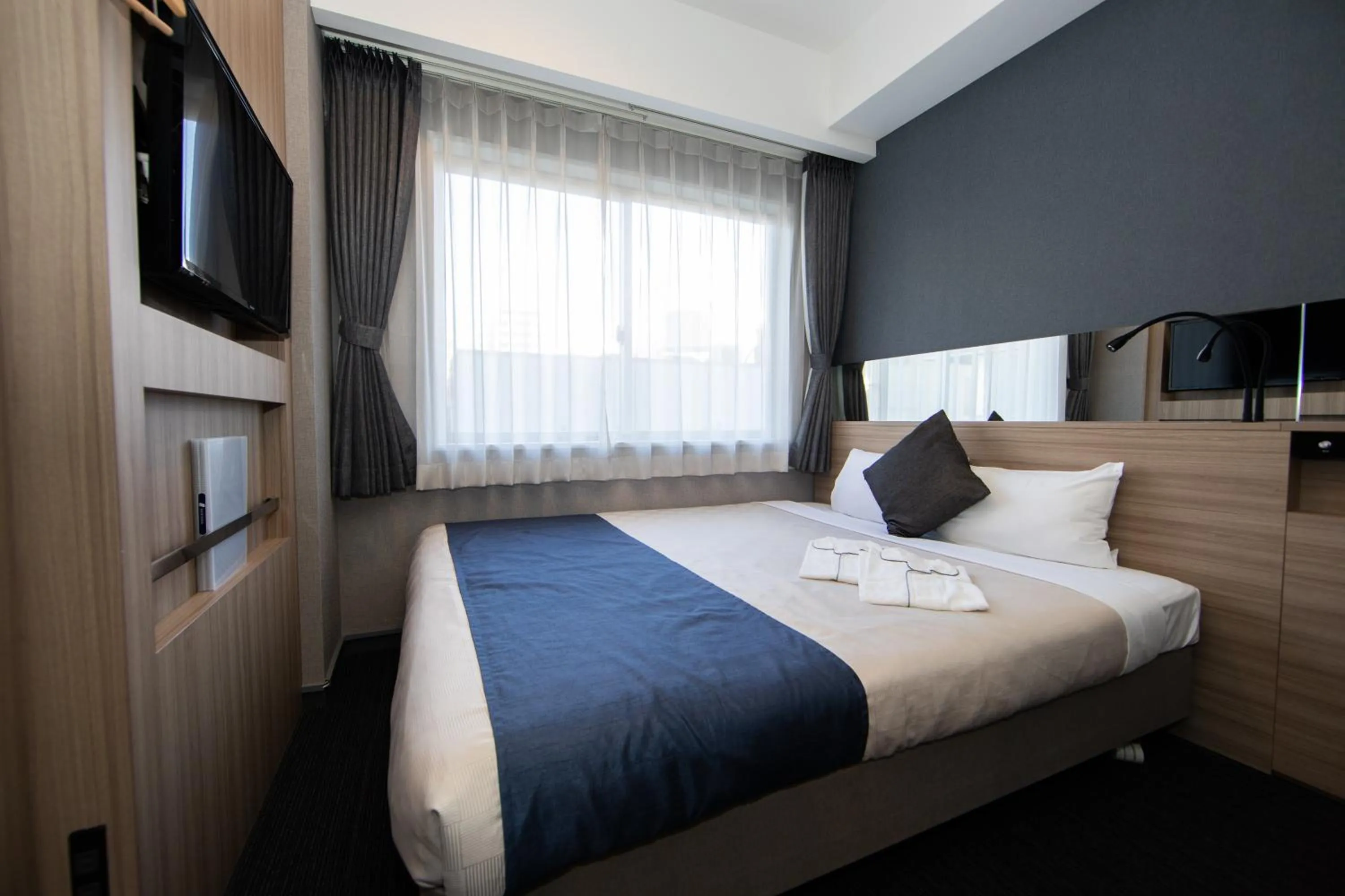 Photo of the whole room, Bed in Quintessa Hotel Osaka Shinsaibashi Comic & Books