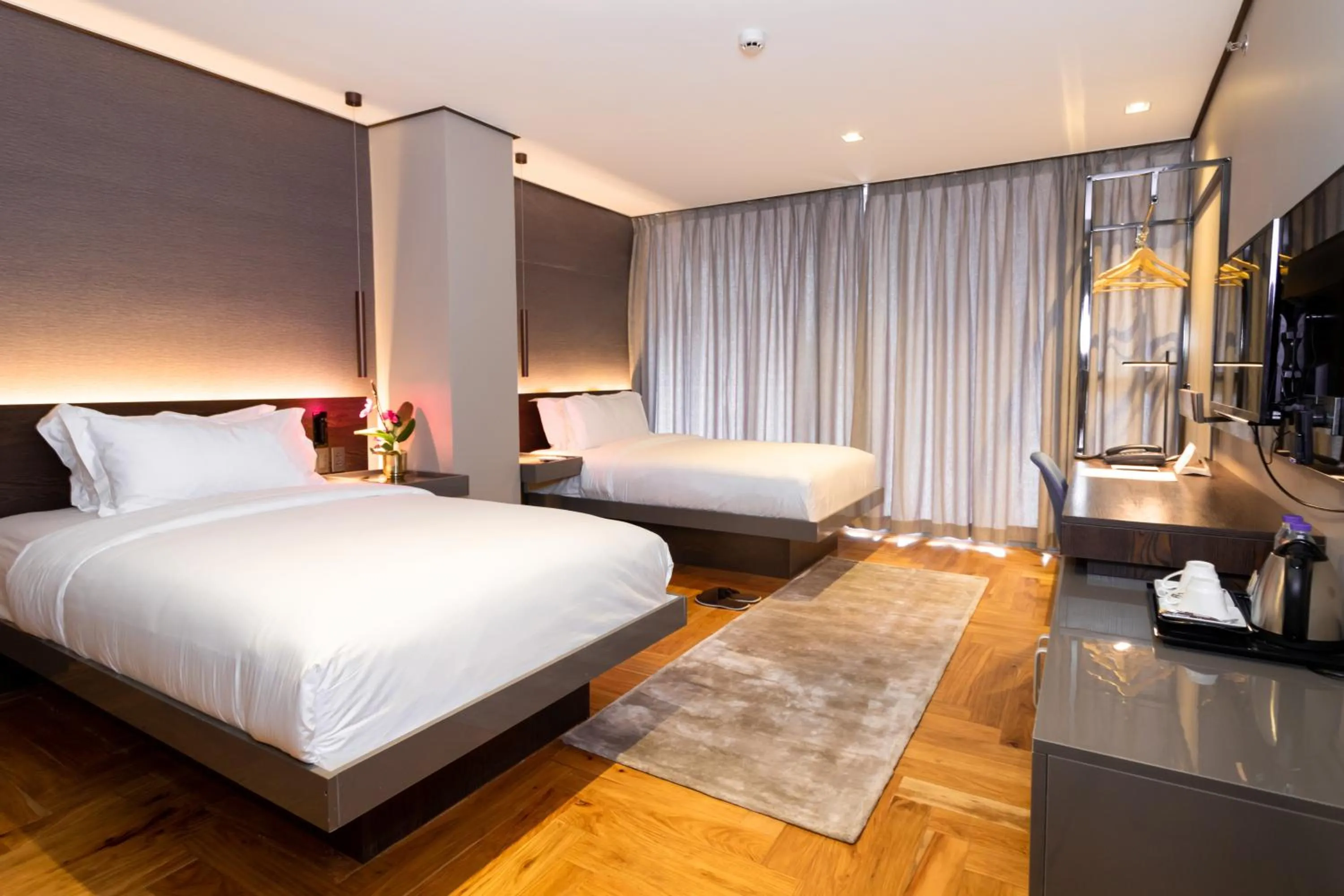 Bed in Ramada Encore by Wyndham Makati