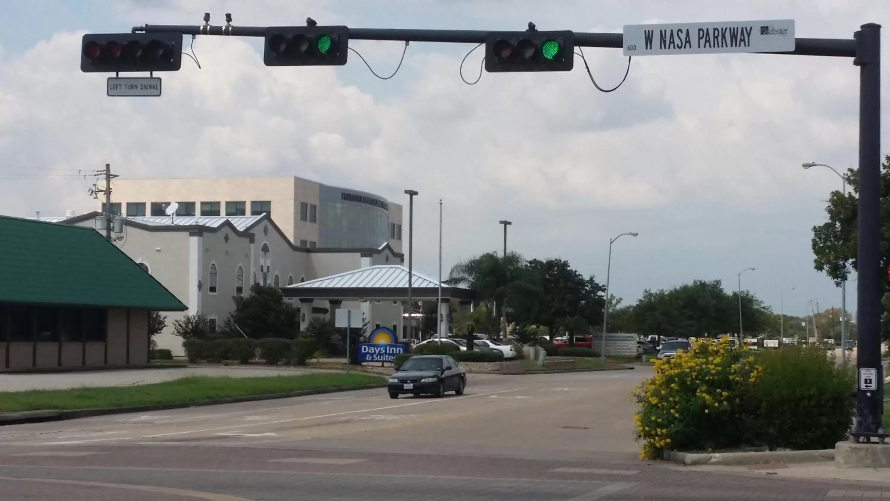 Property logo or sign in Days Inn & Suites by Wyndham Webster NASA-ClearLake-Houston