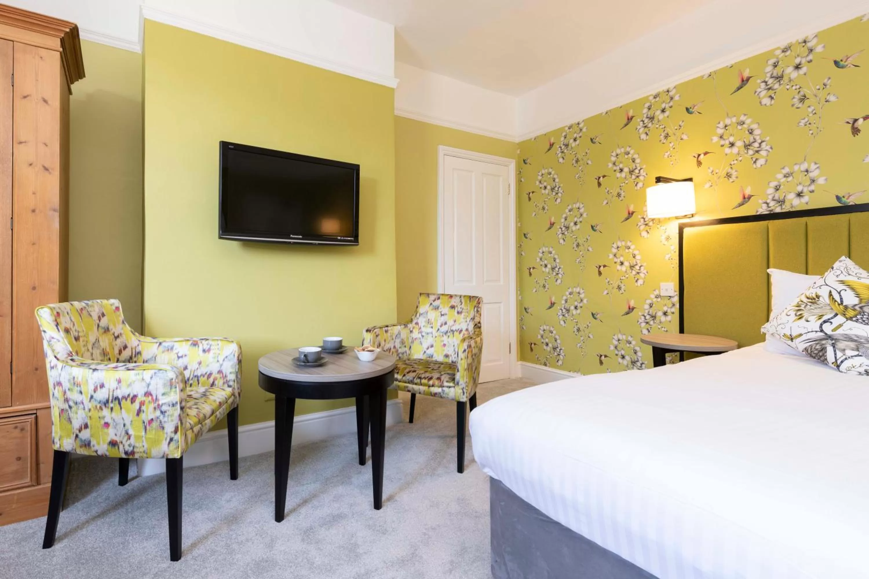 Seating area, Bed in Wisteria Hotel