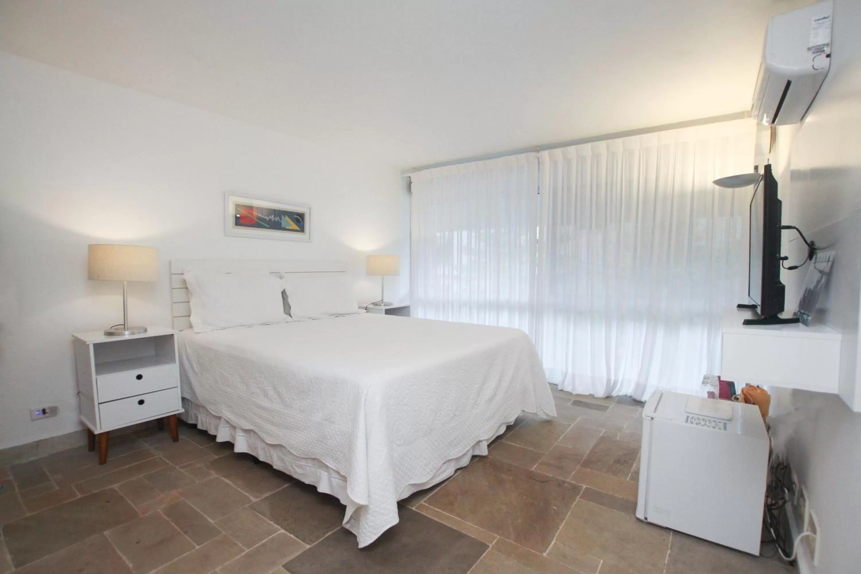 Bed in Guest House Guarujá