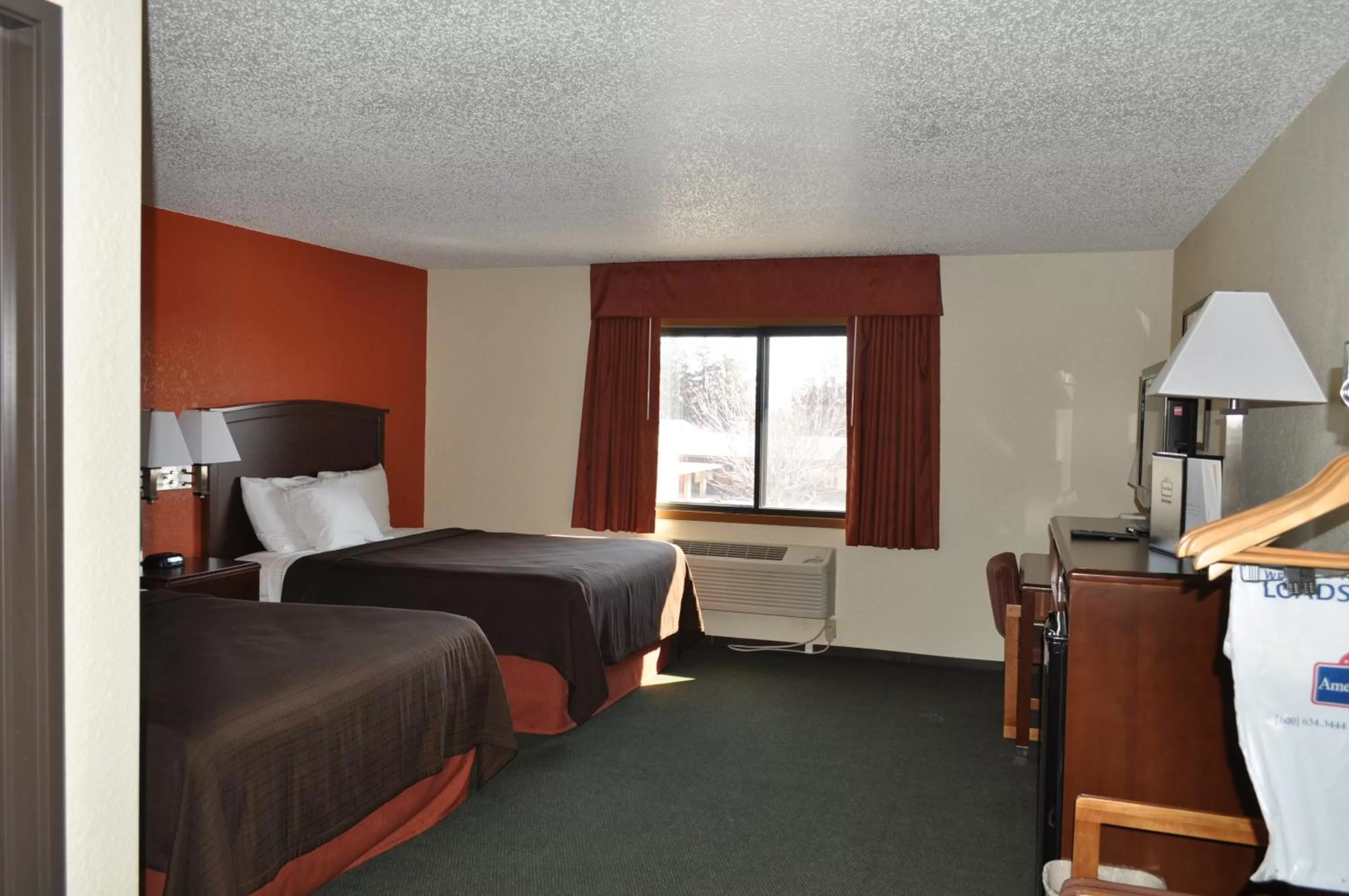 Bed in AmericInn by Wyndham Plymouth