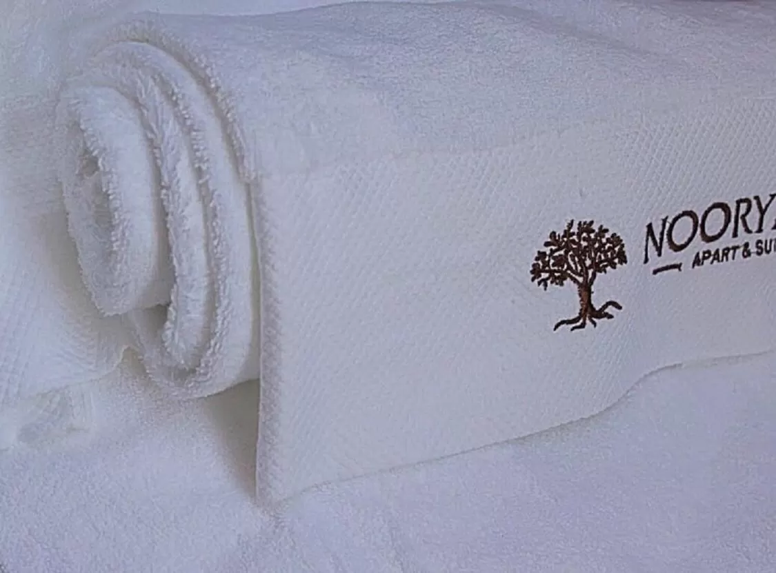 Property logo or sign, Bed in Nooryana Suites and Apartments