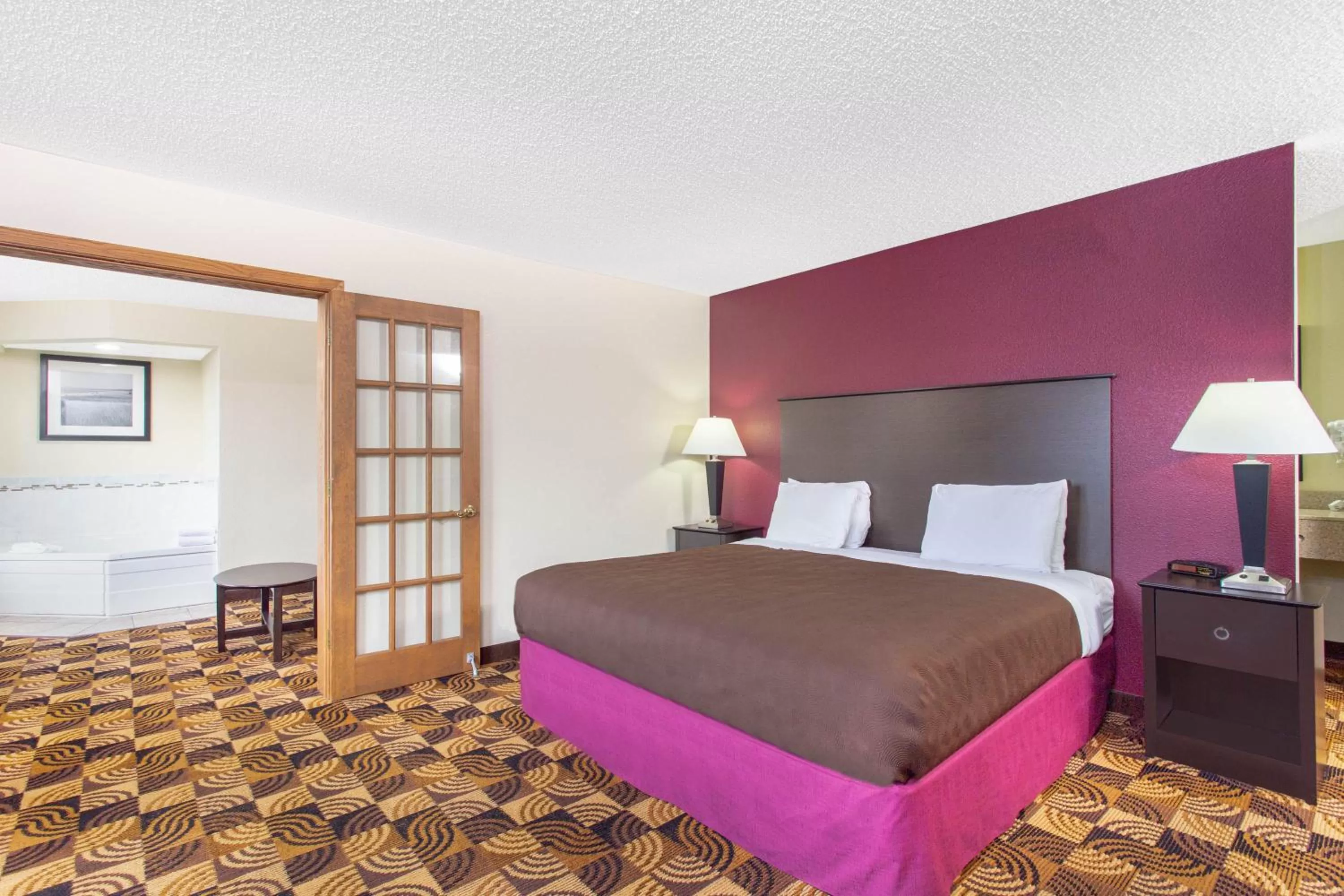 Bed in AmericInn by Wyndham Elkhorn Near Lake Geneva