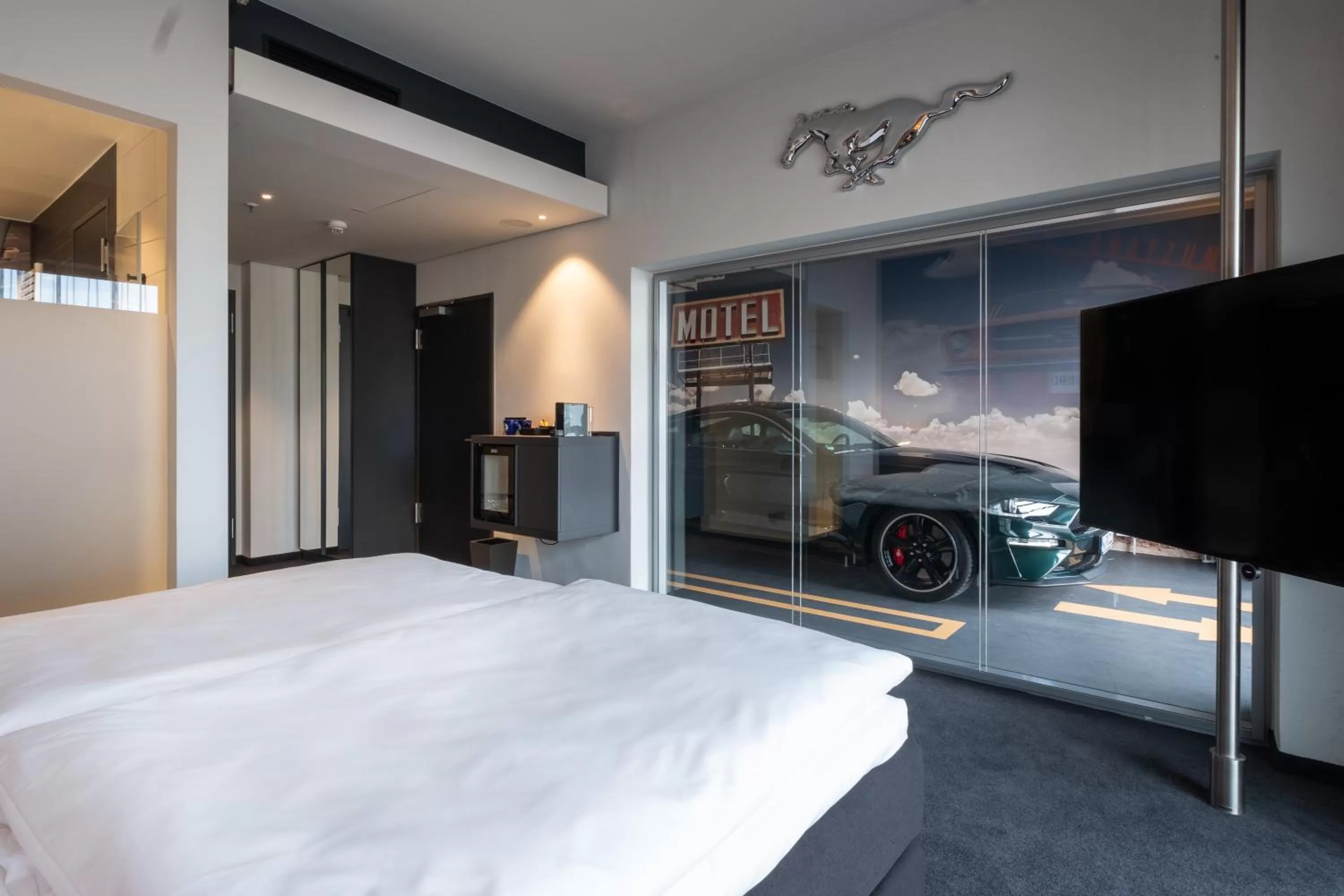 Photo of the whole room, Bed in V8 Hotel Köln at MOTORWORLD