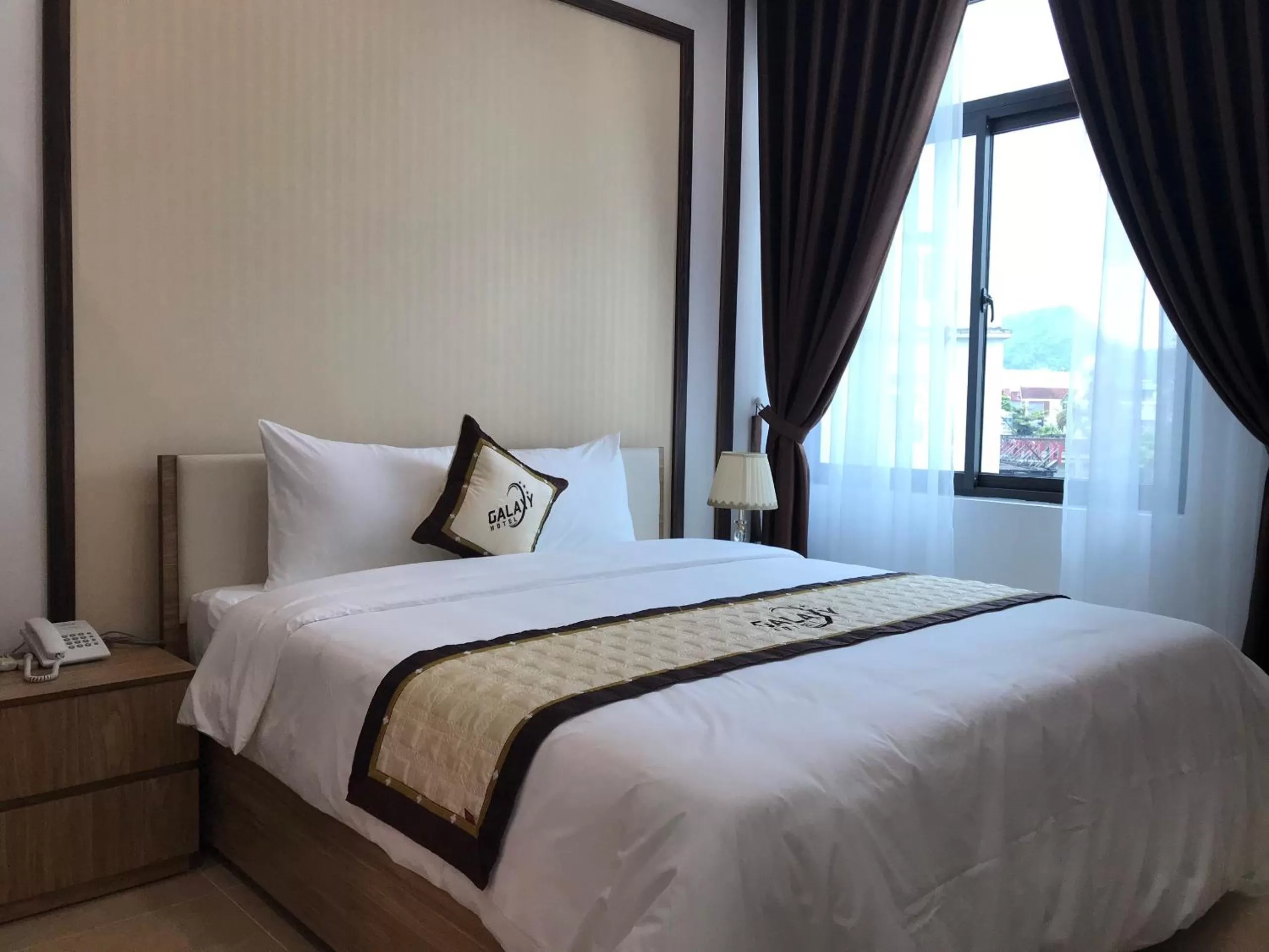 Bed in Galaxy Grand Hotel