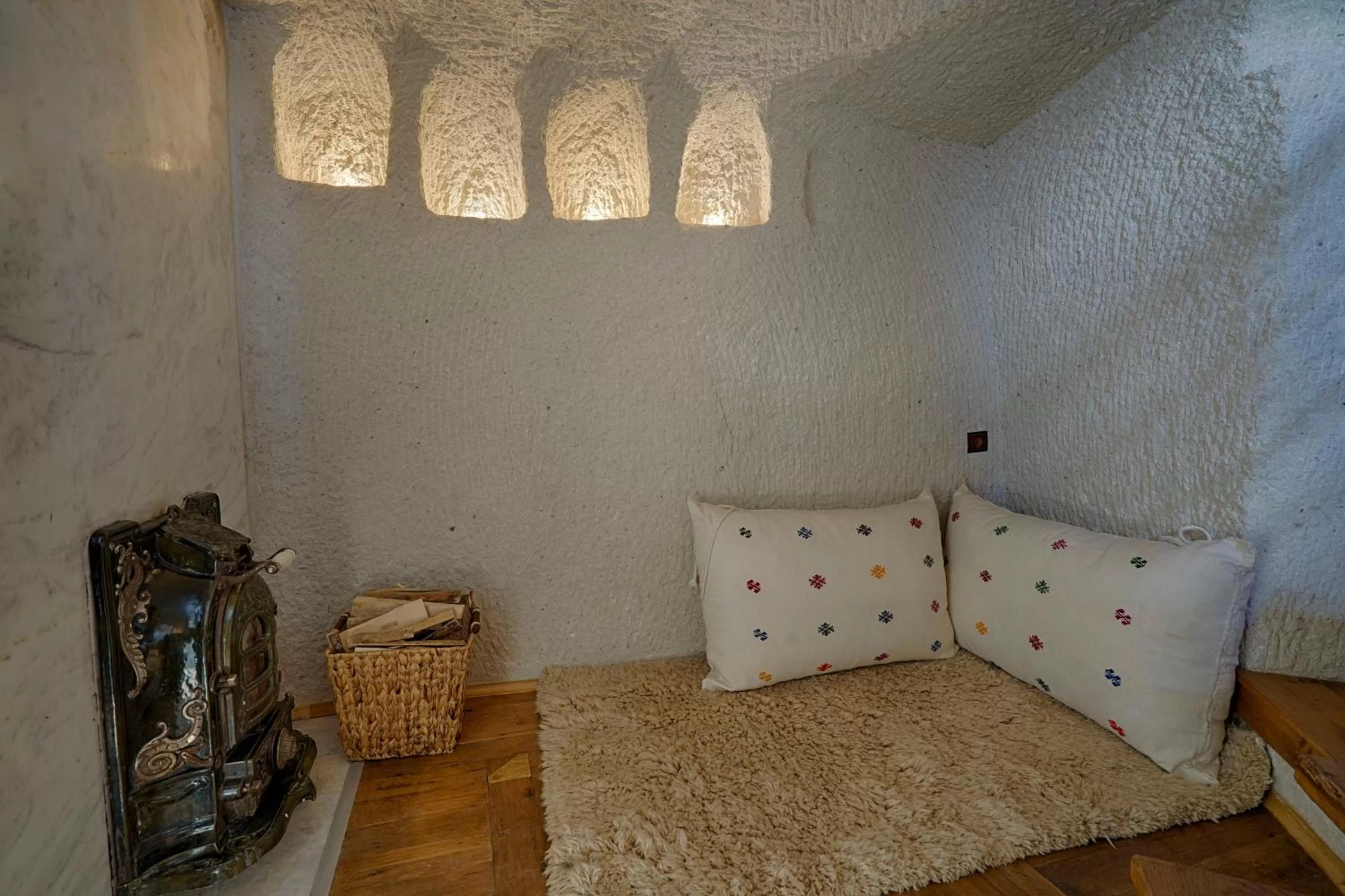 Seating area, Bed in Artemis Cave Suites & Spa- Adults Only