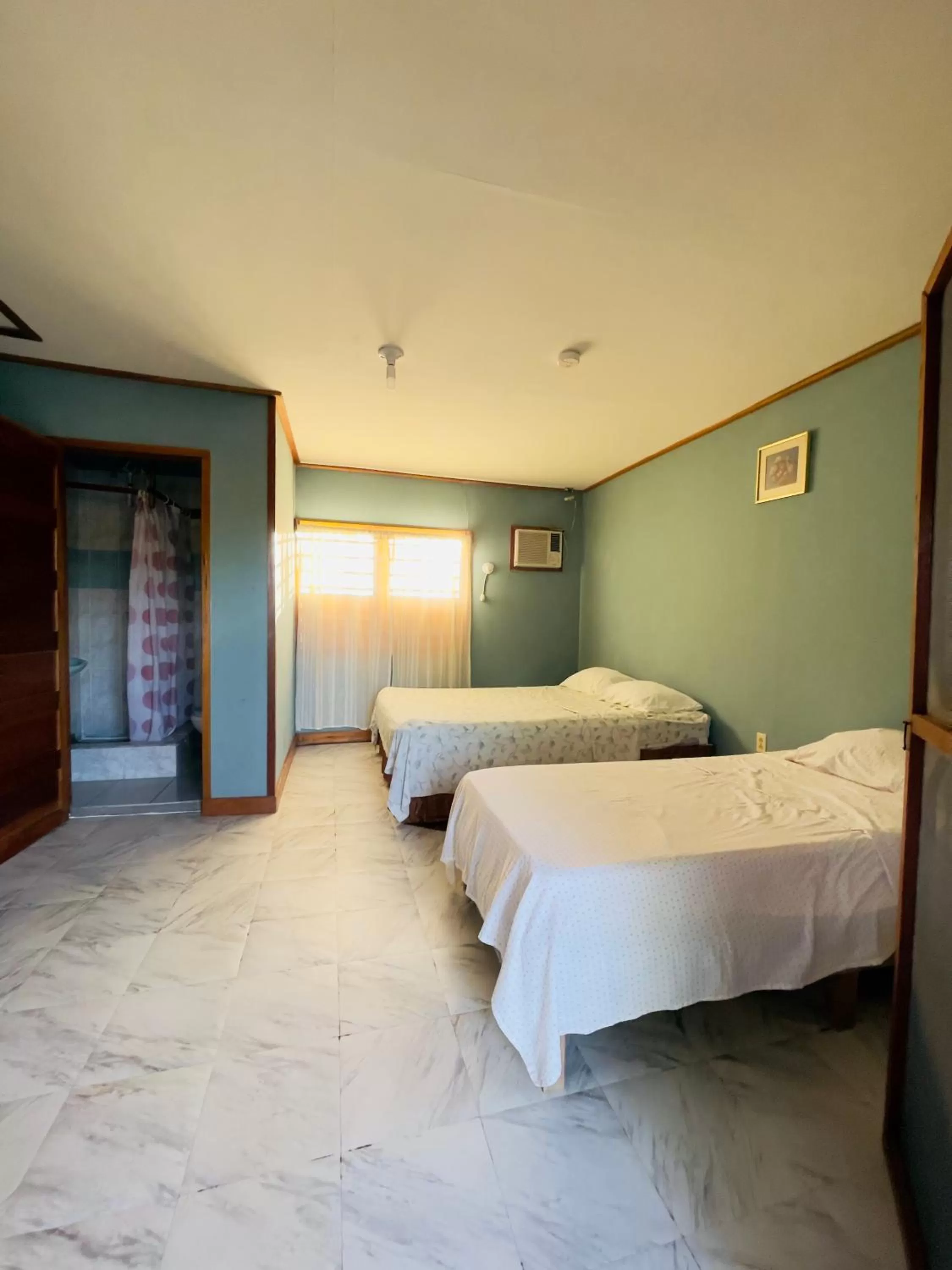 Bed in Lamanai Riverside Retreat