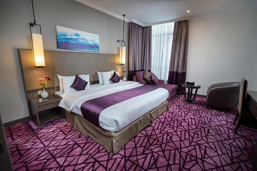 Bedroom in Aquila Al Hamra Hotel