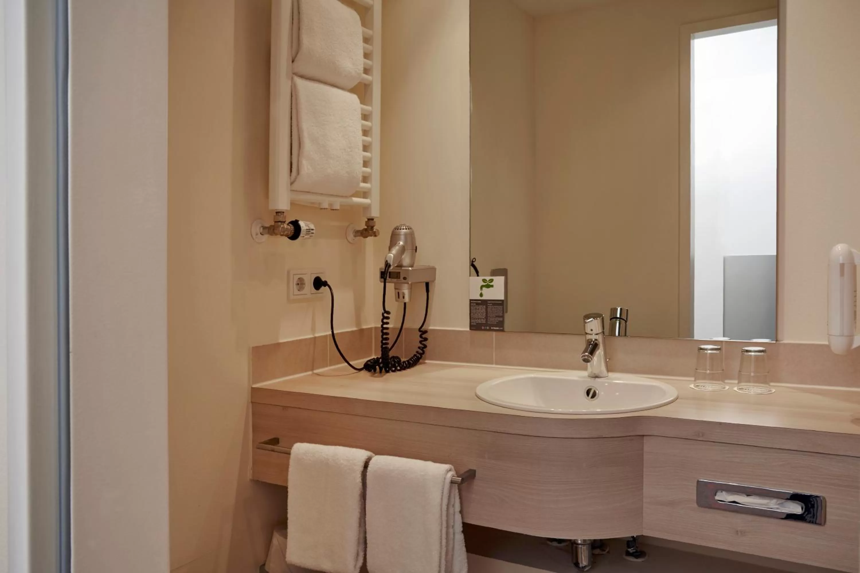 Bathroom in H+ Hotel München