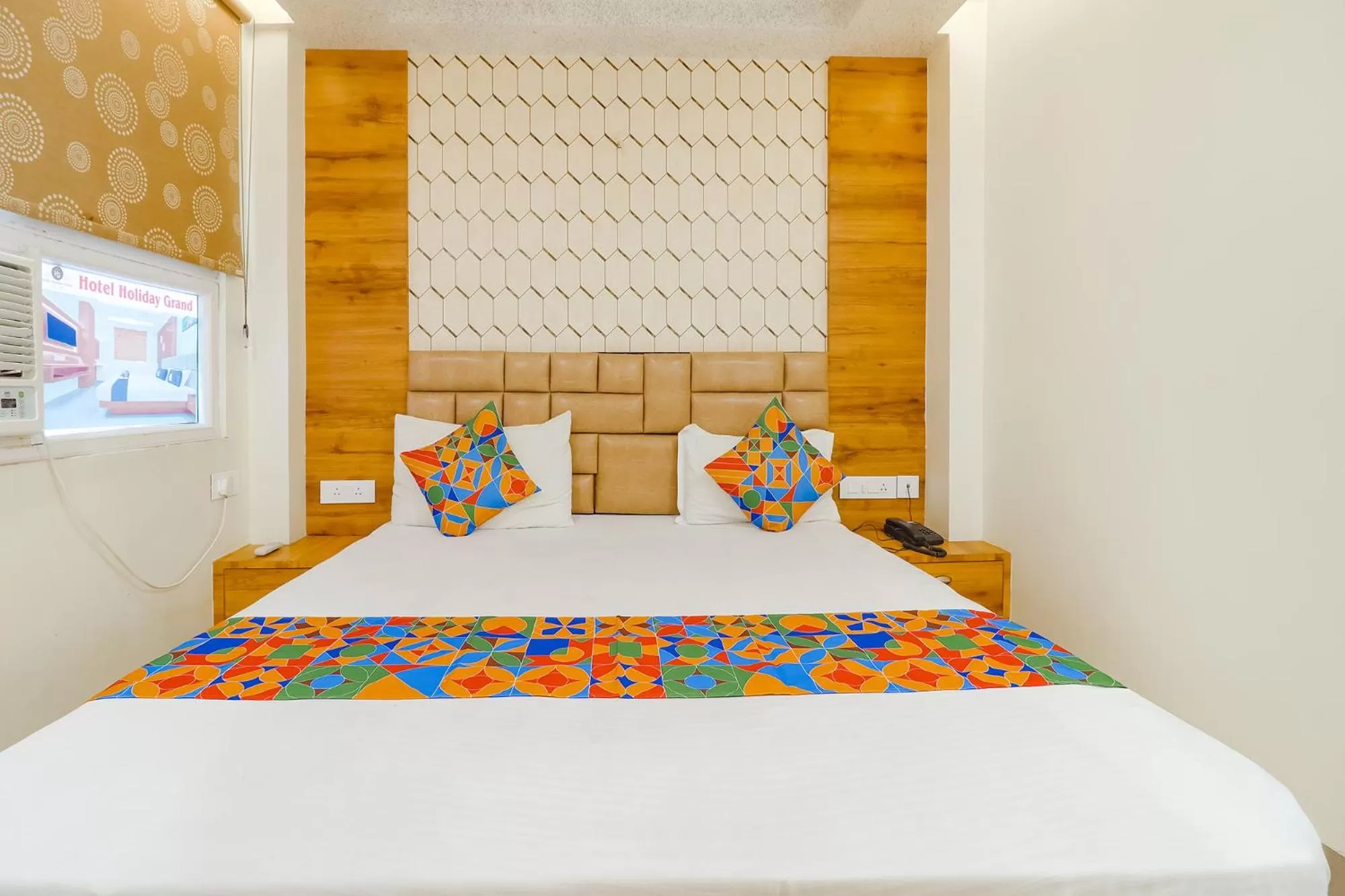 Bed in FabHotel Holiday Grand