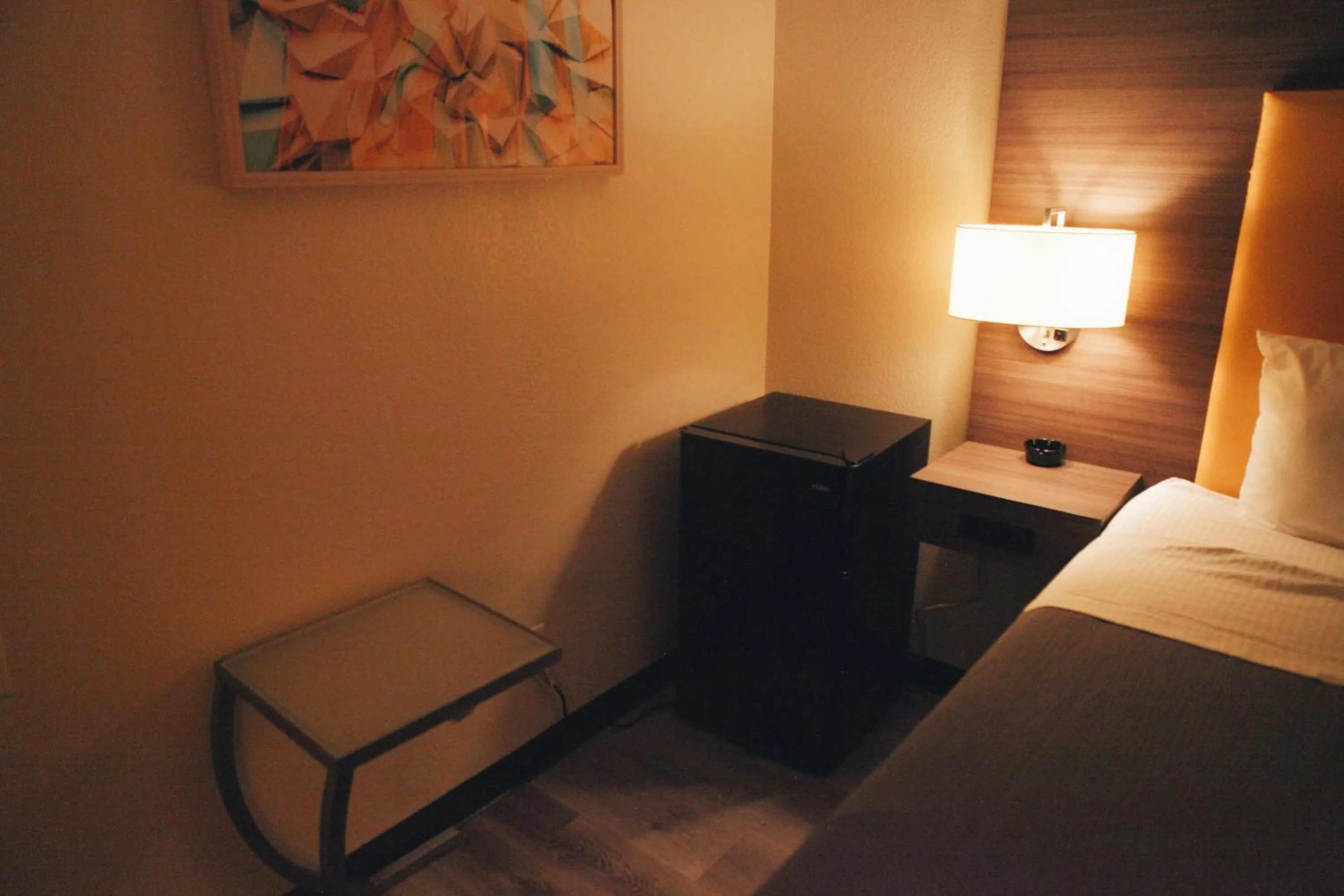 Bed in All Seasons Inn & Suites