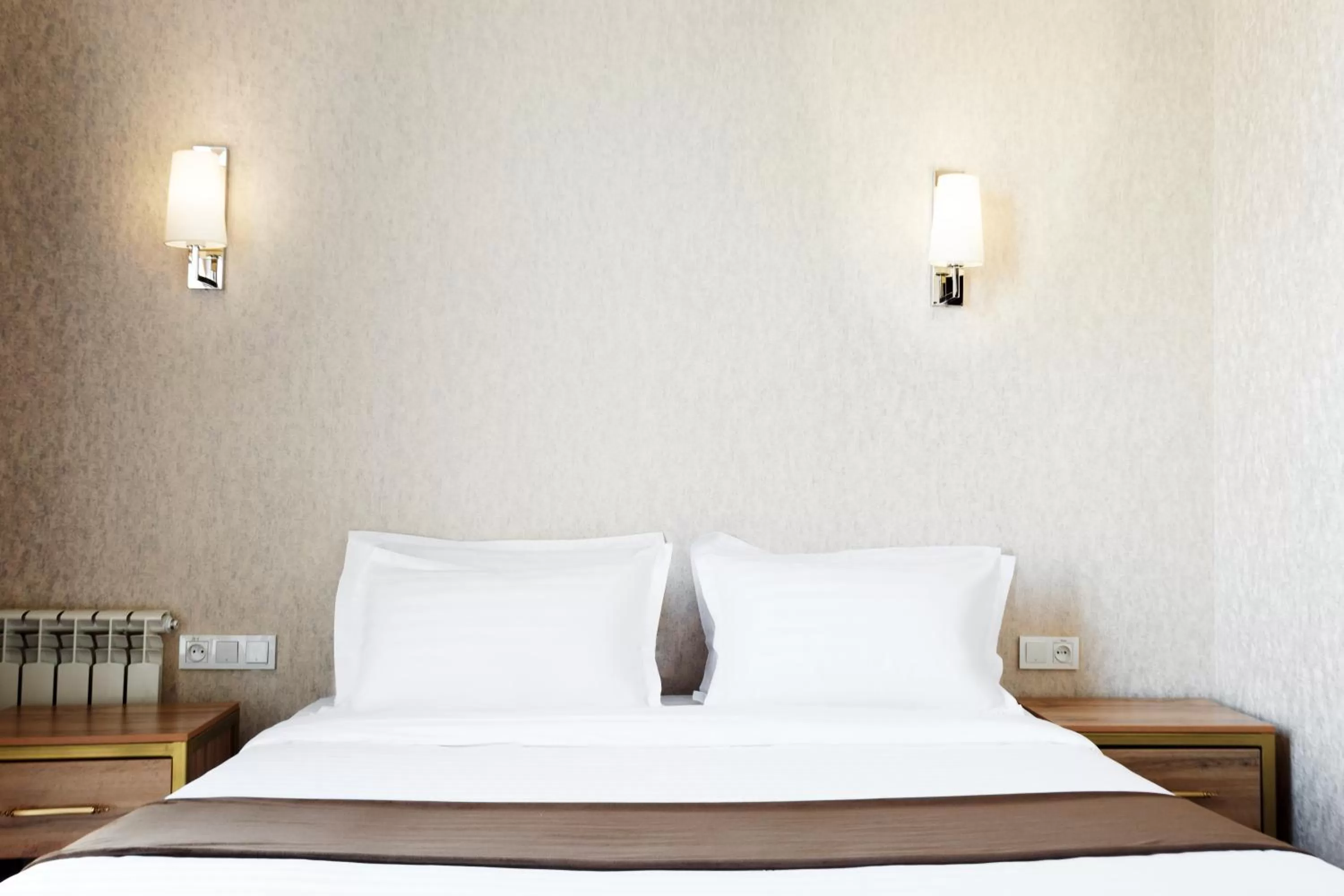 Bed in Western Suites Hotel