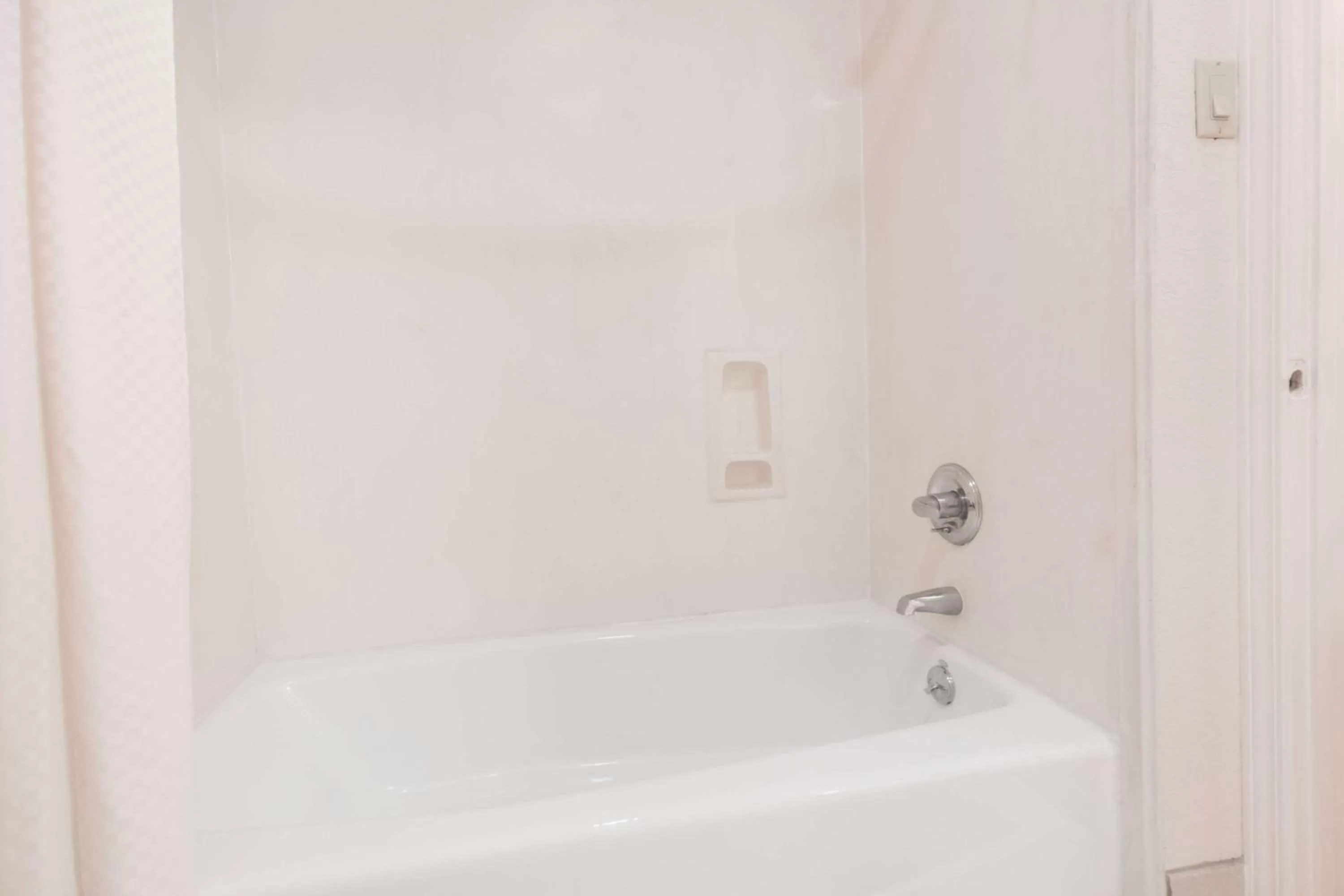 Bathroom in Days Inn & Suites by Wyndham Winnie