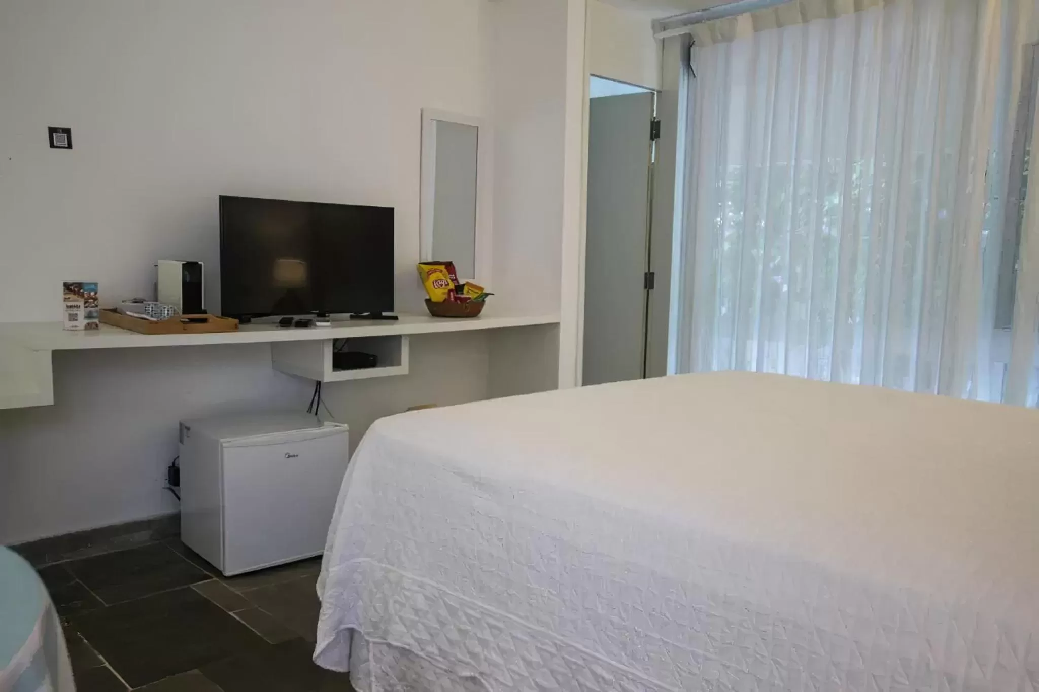 Bed in Guest House Guarujá