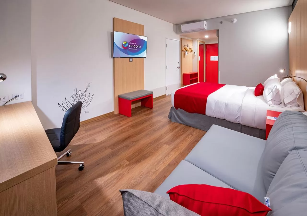 Seating area, Bed in Ramada Encore by Wyndham Guadalajara Aeropuerto